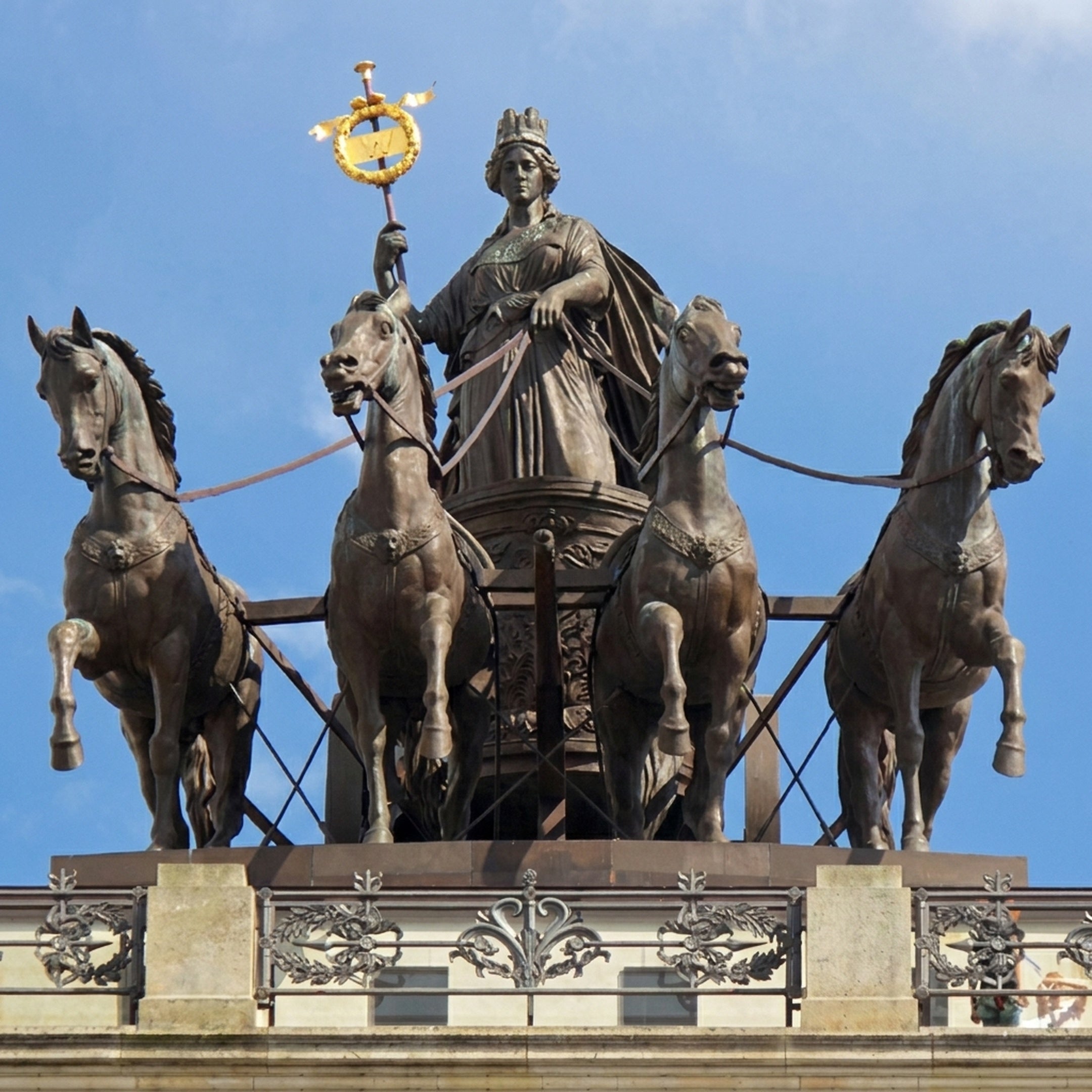 Giant Sculptures Monumental Classical Quadriga Bronze Sculpture atop a building, showing a crowned goddess holding a gilded laurel wreath staff and reins of four horses.