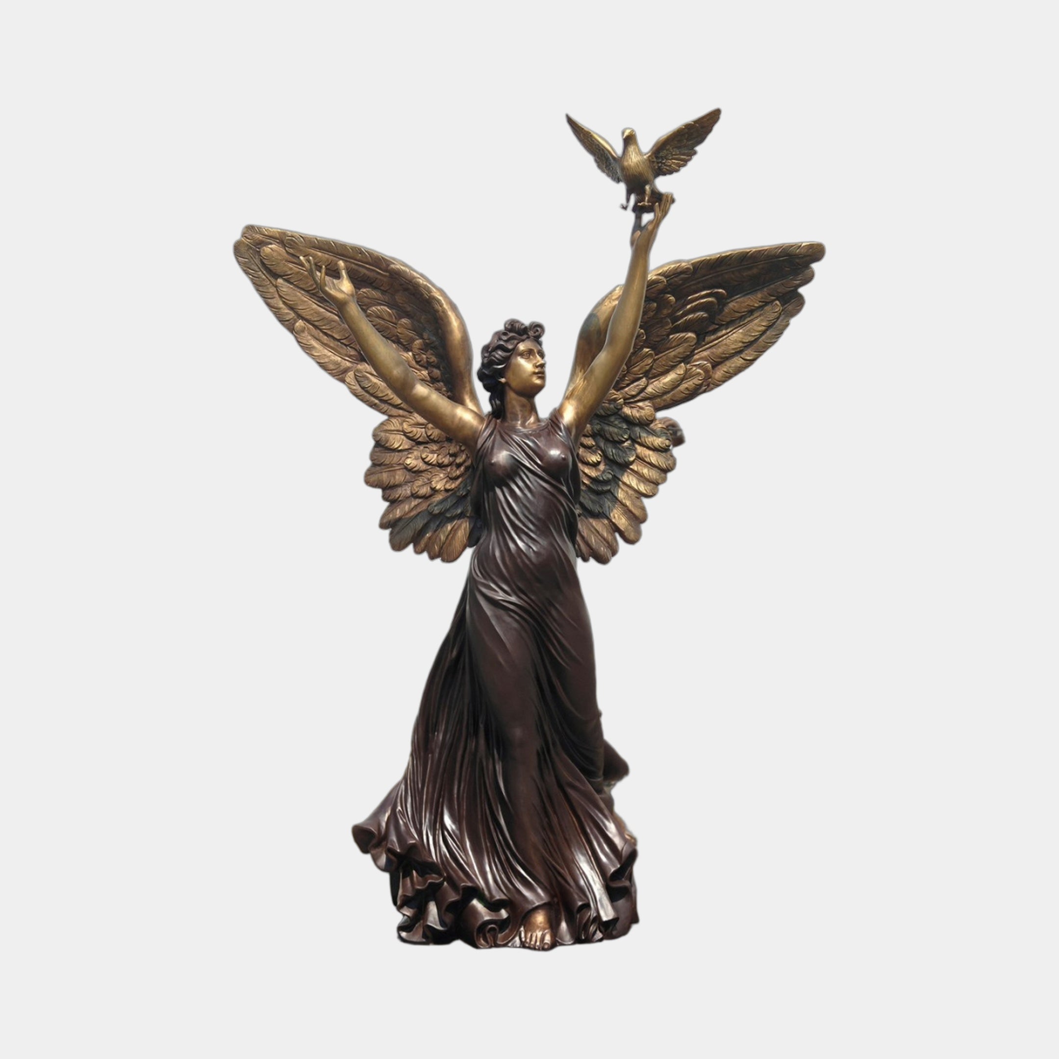 Monumental Classical Standing Angel Bronze Sculpture by Giant Sculptures, winged figure in flowing robes releasing a dove from a raised hand, on plain background.