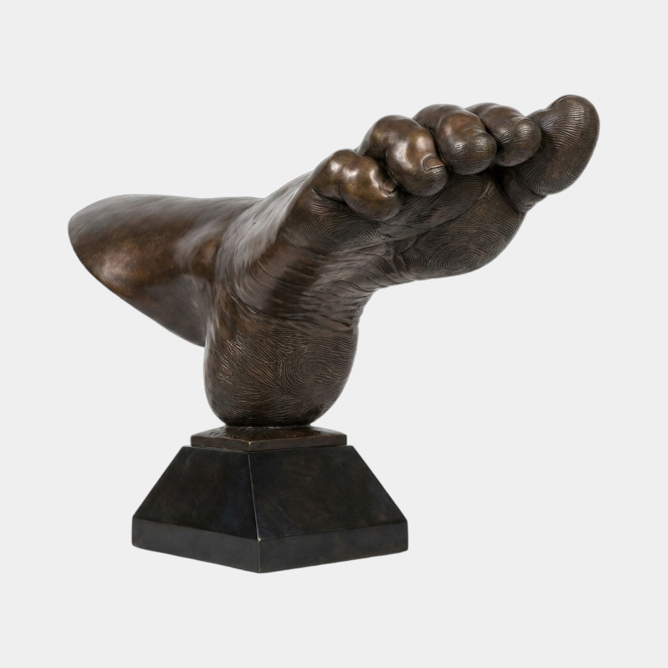 Monumental Contemporary Oversized Human Foot Bronze Sculpture by Giant Sculptures, sole-forward with curled toes, deep brown patina, on a black plinth.