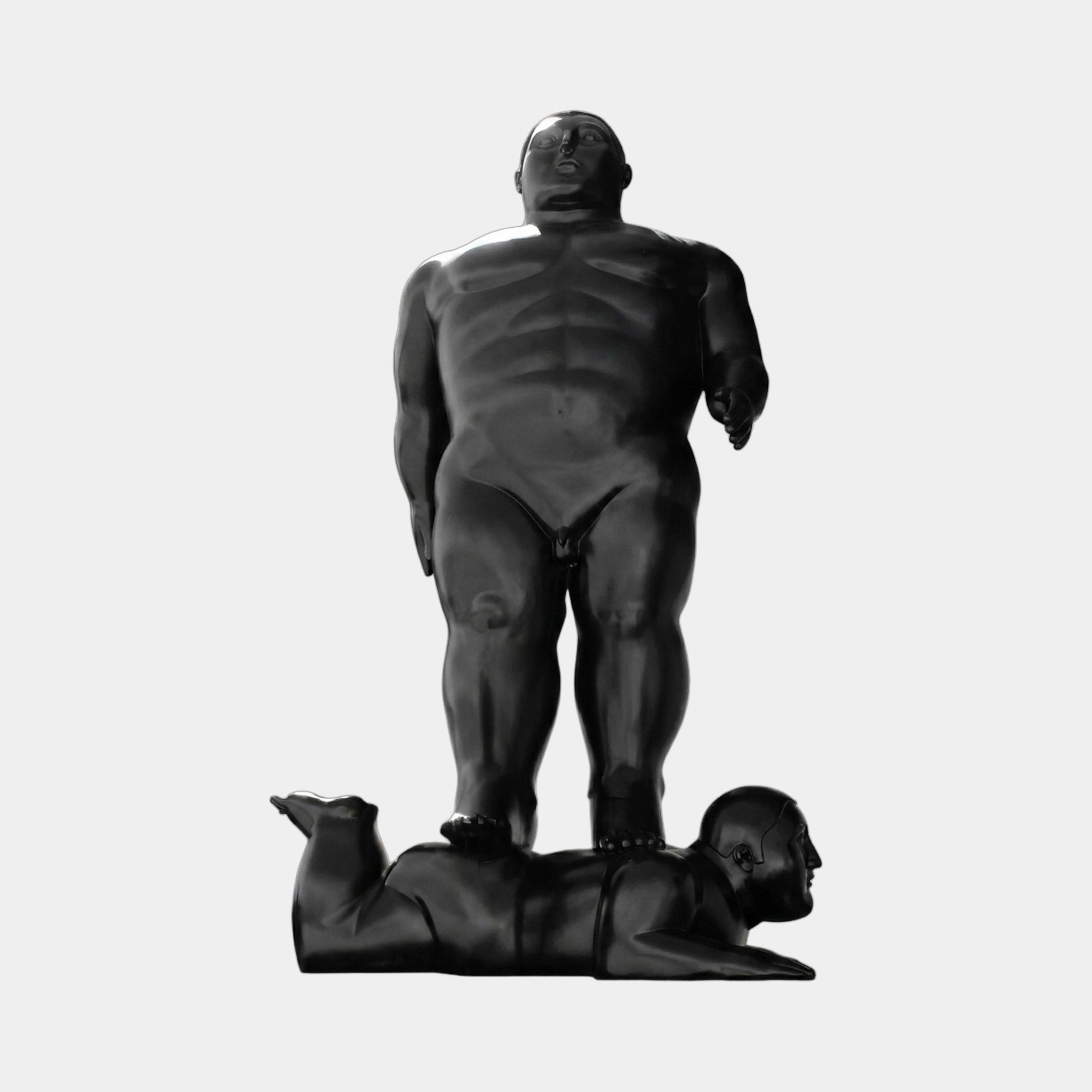Monumental Rotund Standing Figure Bronze Sculpture by Giant Sculptures in near-black patina, depicting a nude figure standing atop a prostrate figure, on a plain background.