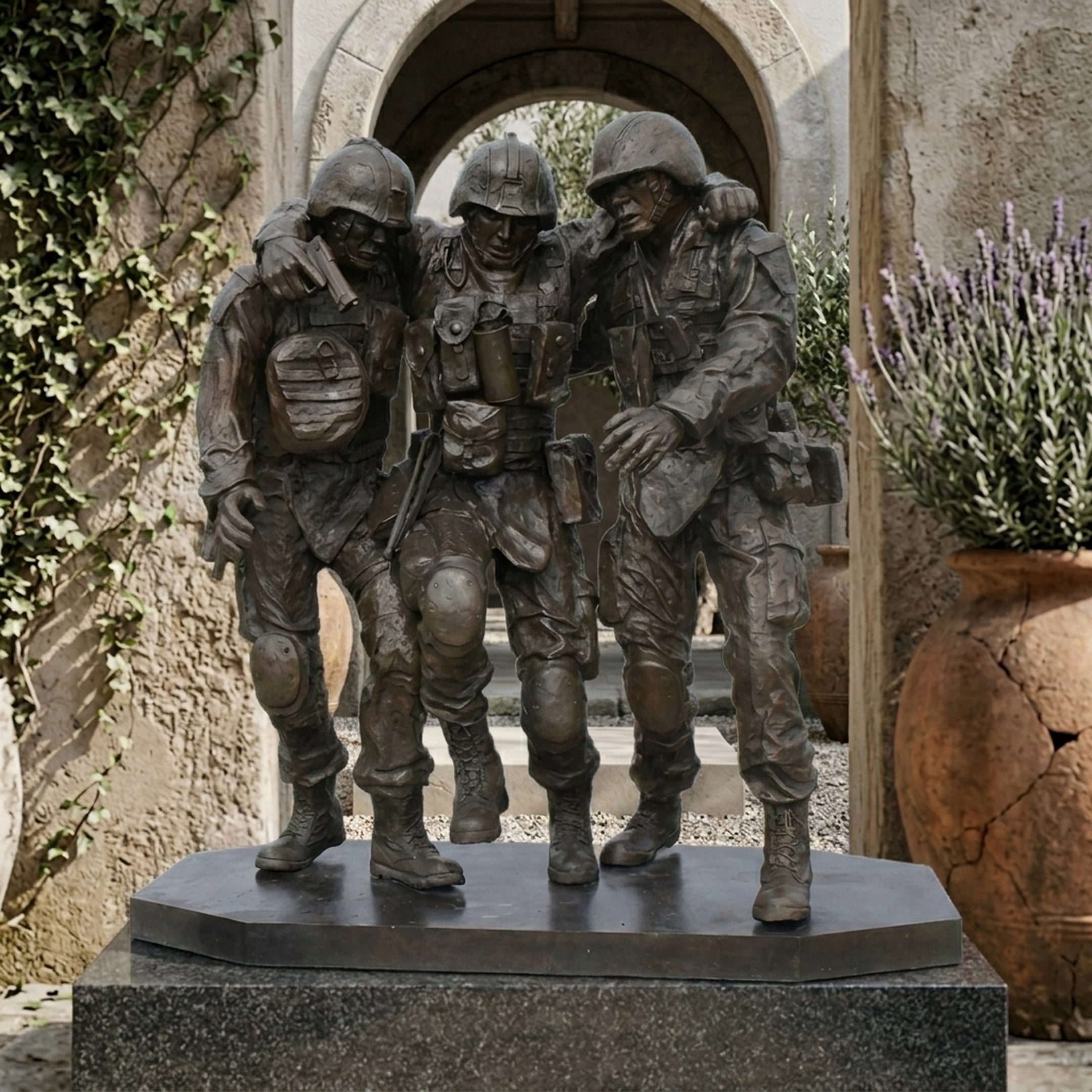 Monumental Contemporary Three Soldiers Bronze Sculpture by Giant Sculptures, dark patina figures carrying a wounded comrade, displayed on granite before a stone archway.