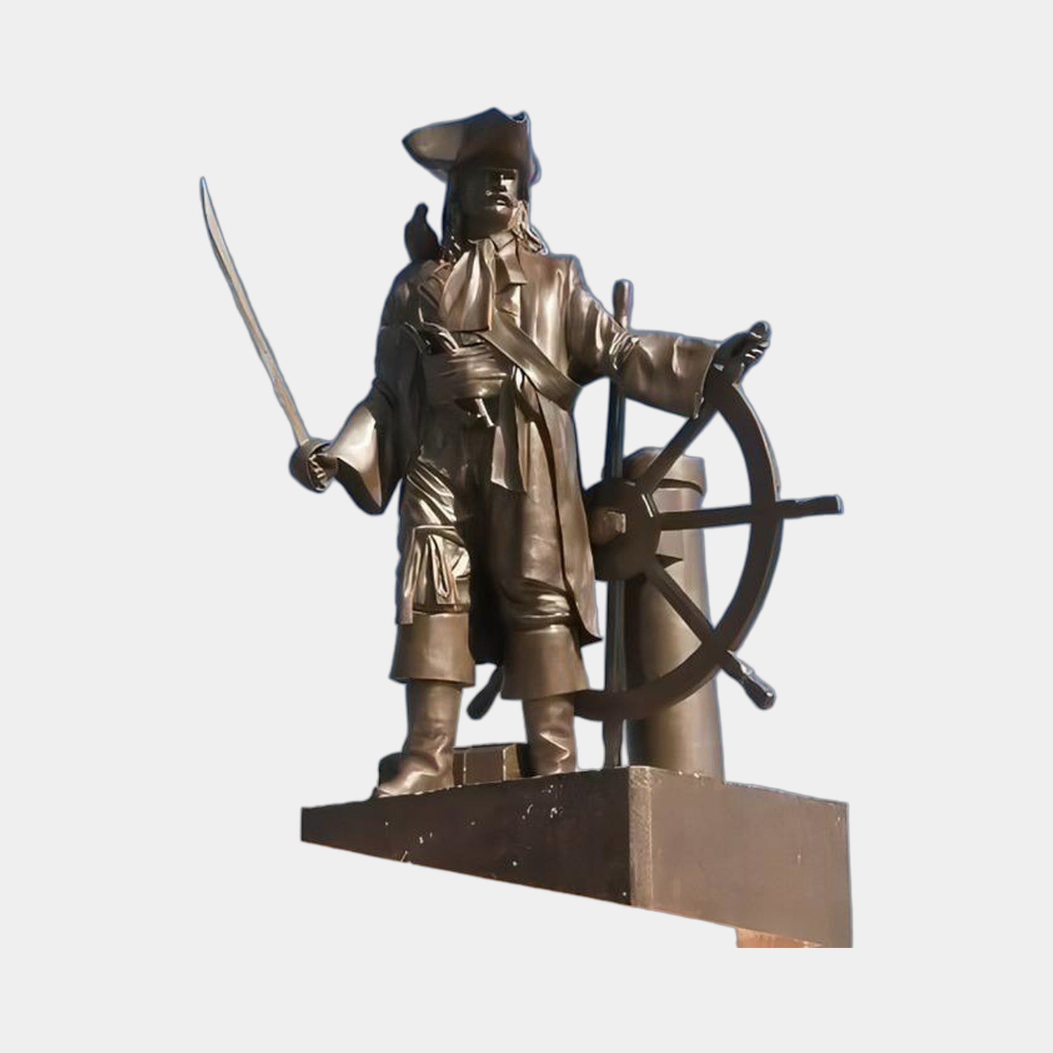 Monumental Traditional Pirate Captain Bronze Sculpture by Giant Sculptures, cutlass raised and hand on ship's wheel, golden-brown patina, plain background.