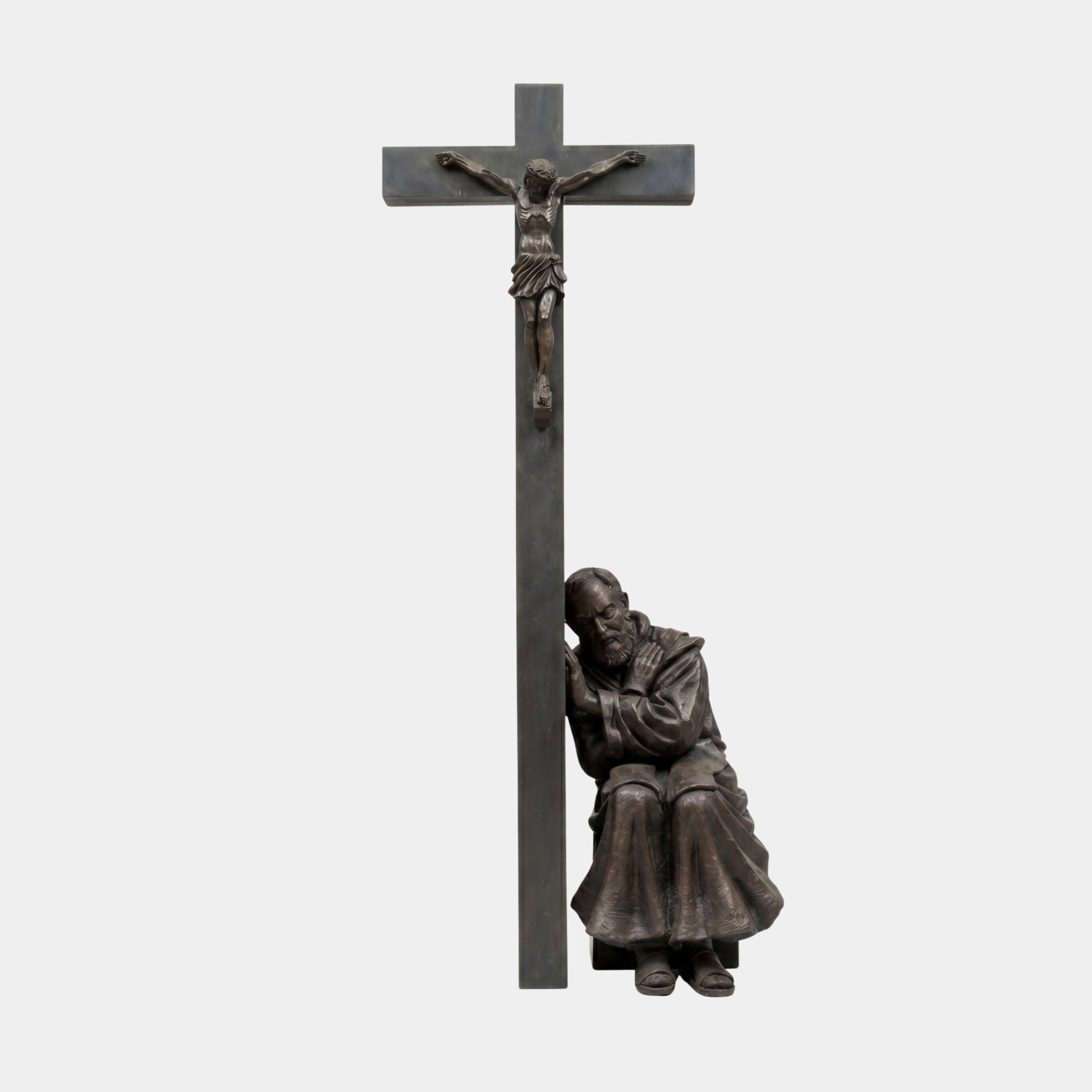 Monumental Traditional Praying Saint and Crucifix Bronze Sculpture by Giant Sculptures, 350cm, dark patina, saint seated at foot of cross with Christ above.