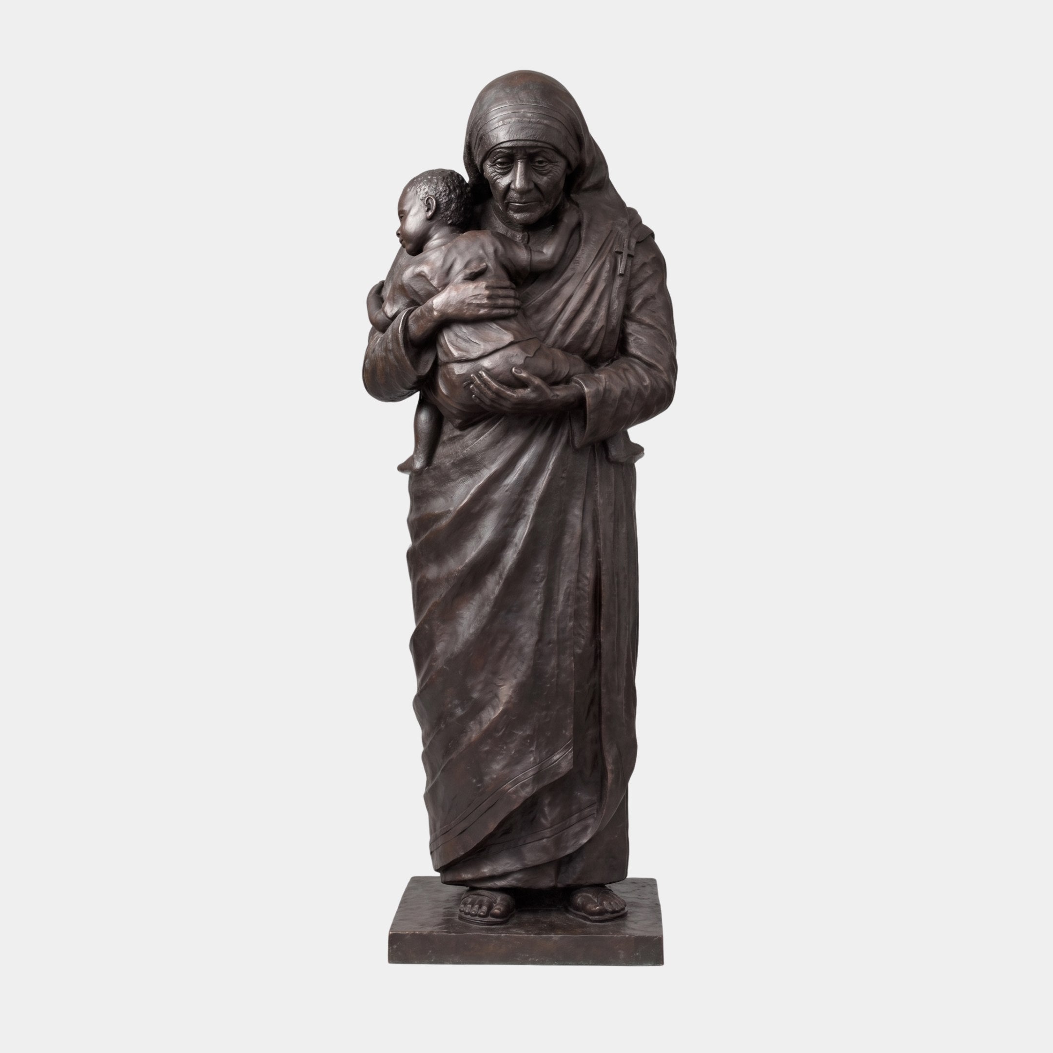 Monumental Traditional Robed Woman and Child Bronze Statue by Giant Sculptures, standing figure in striped head covering cradling a child, dark patina, plain background.