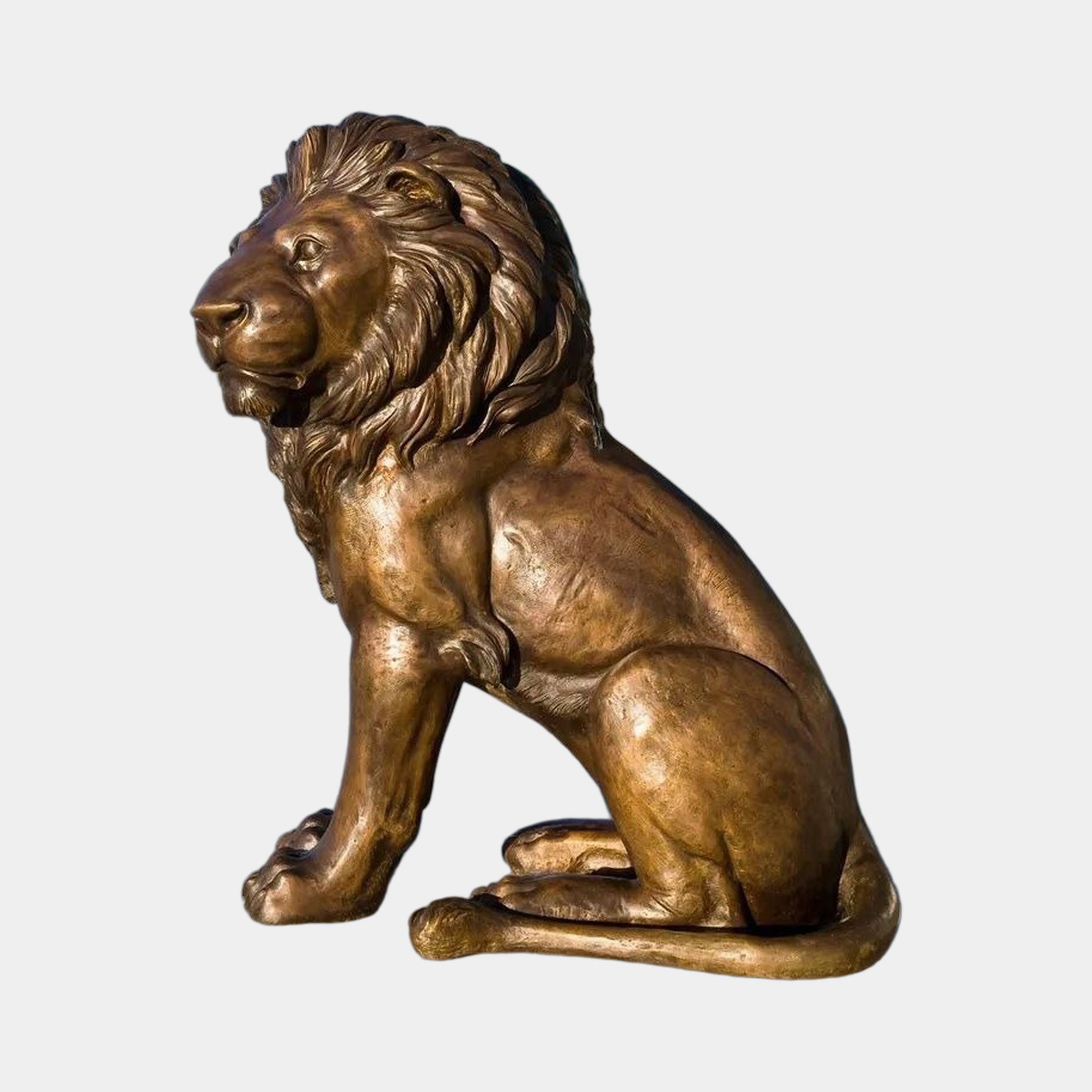 Monumental Traditional Seated Lion Bronze Sculpture by Giant Sculptures in warm golden-brown patina, shown in side profile with detailed flowing mane on a plain background.