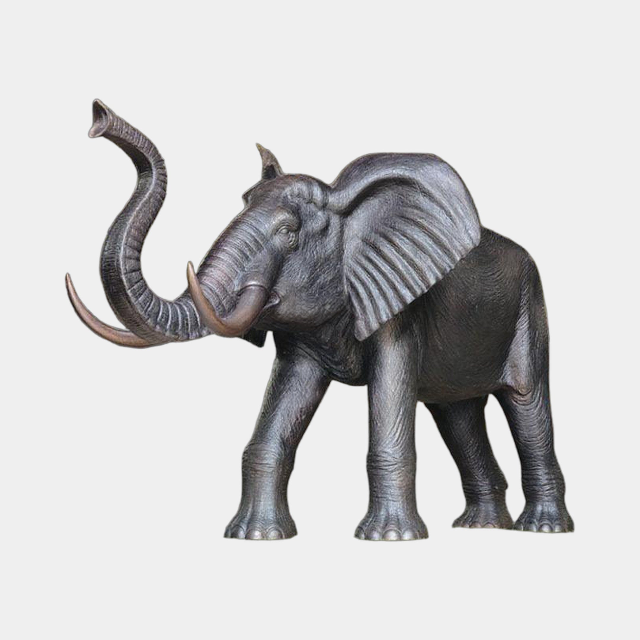 Monumental Traditional Standing Elephant Bronze Sculpture by Giant Sculptures, trunk raised and ears flared, dark patina with bronze tusks, on plain background.