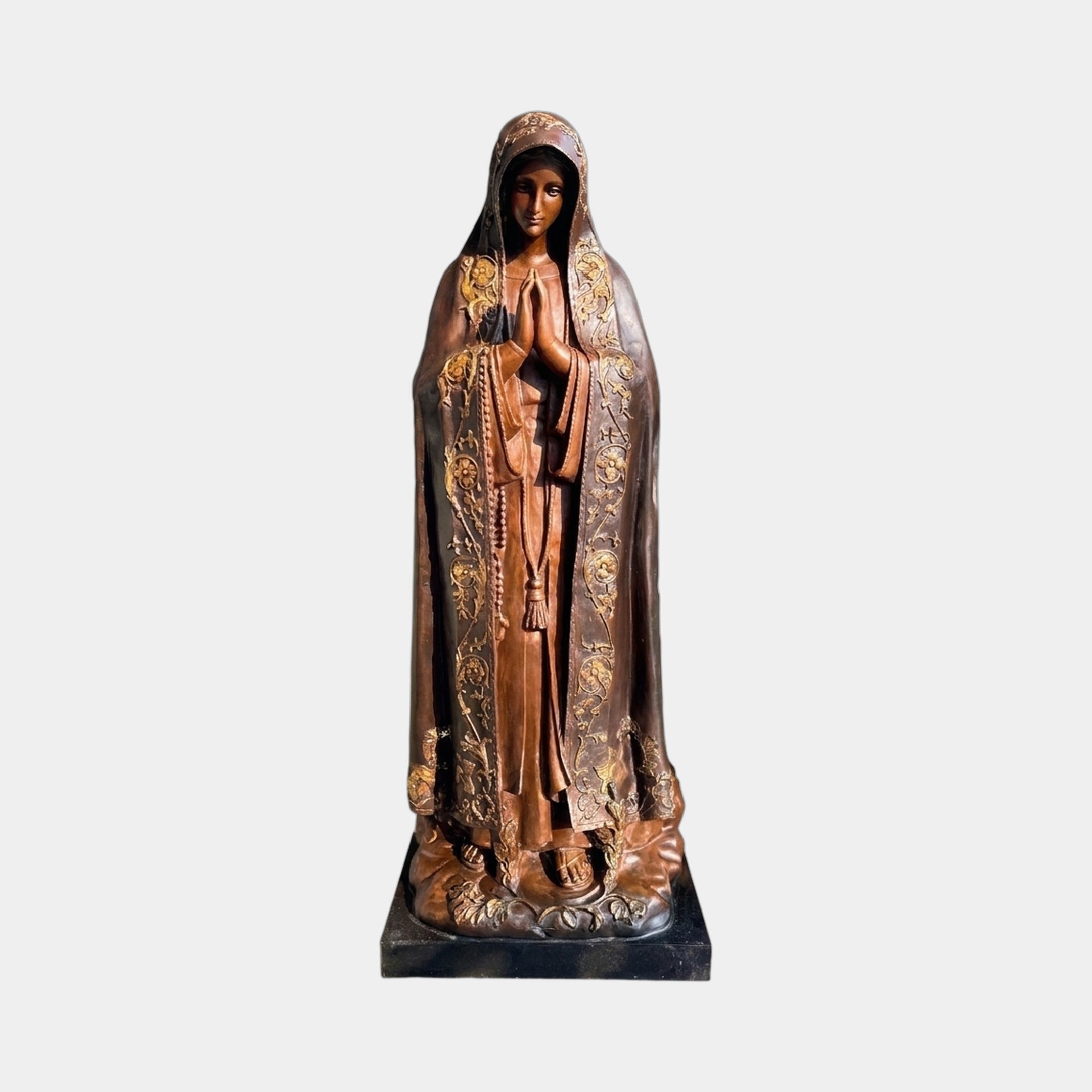 Monumental Traditional Virgin Mary Bronze Statue by Giant Sculptures, frontal view with clasped hands, rosary, and gold-toned floral mantle border on dark base.