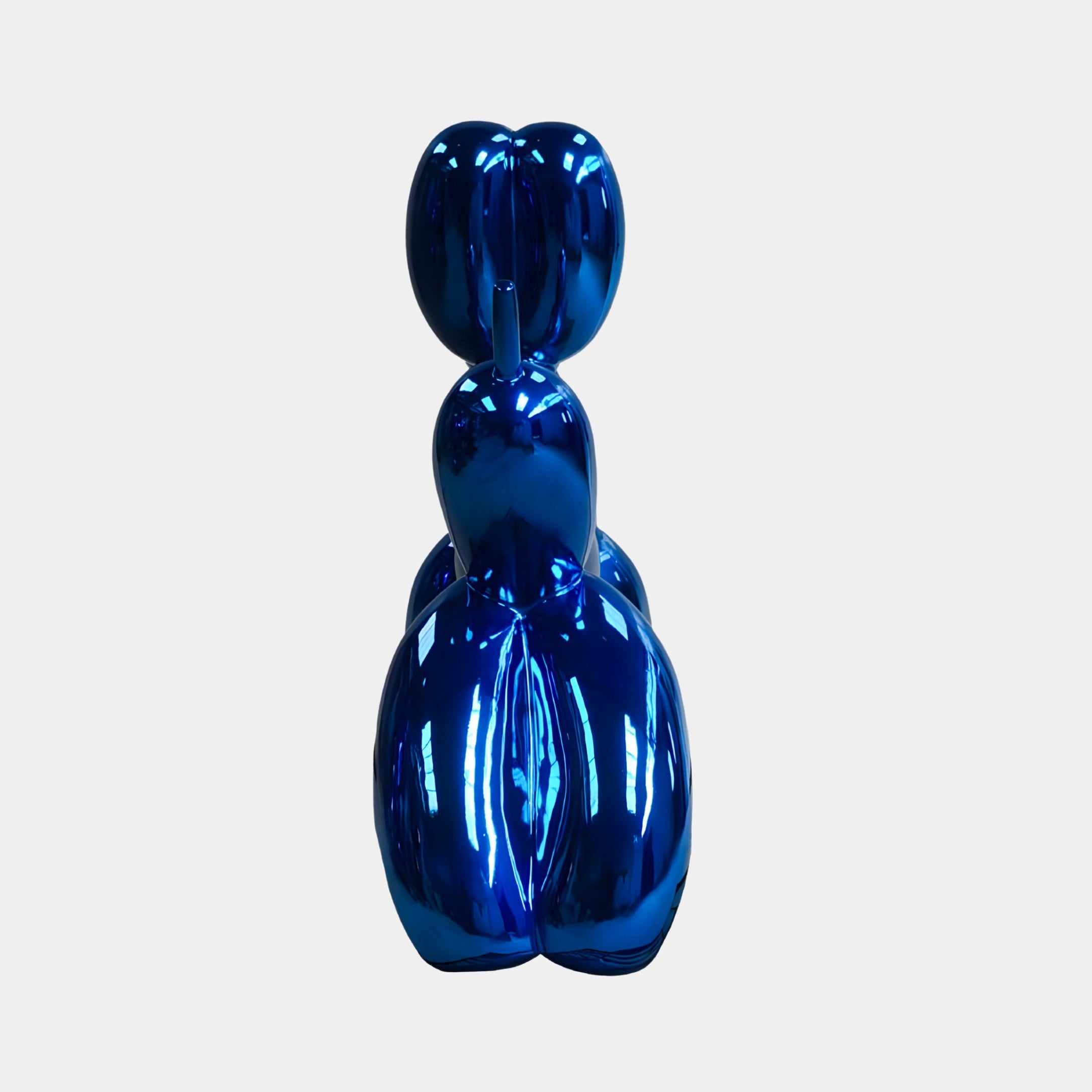The Ocean Blue Balloon Dog Sculpture (80cm) from Giant Sculptures features a shiny, reflective surface, adding an eye-catching element to contemporary interiors, reminiscent of a modern art rabbit balloon animal.