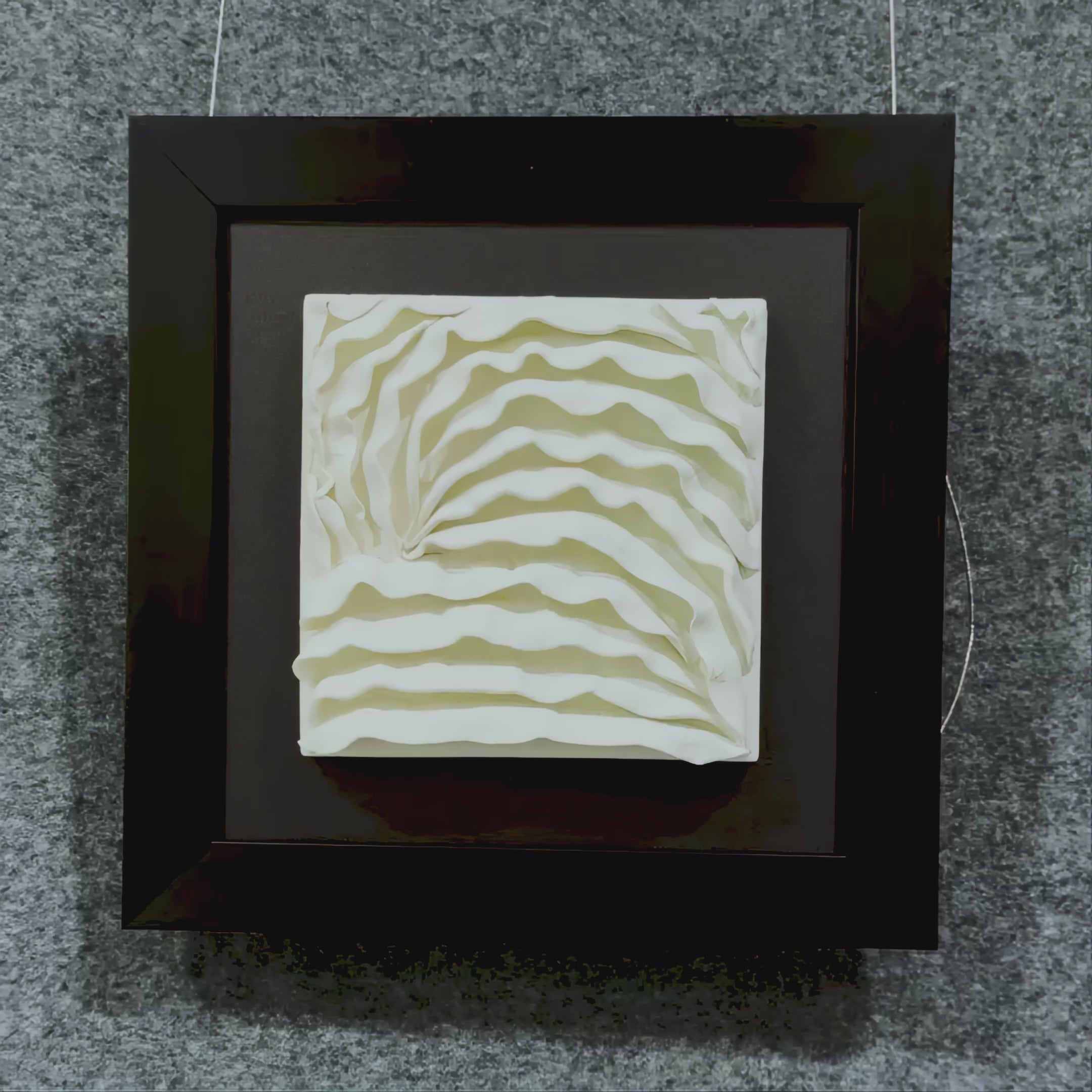 A Video showcasing the Harmonia 3D Ceramic Wave Wall Sculpture, featuring flowing cream-toned wave textures on ceramic, mounted on dark fabric and framed in black for bold contrast