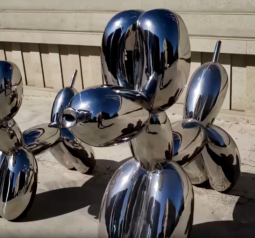 Video showcasing two reflective mystic chrome balloon dog sculptures rotating to reveal its glossy metallic finish and pop art appeal.