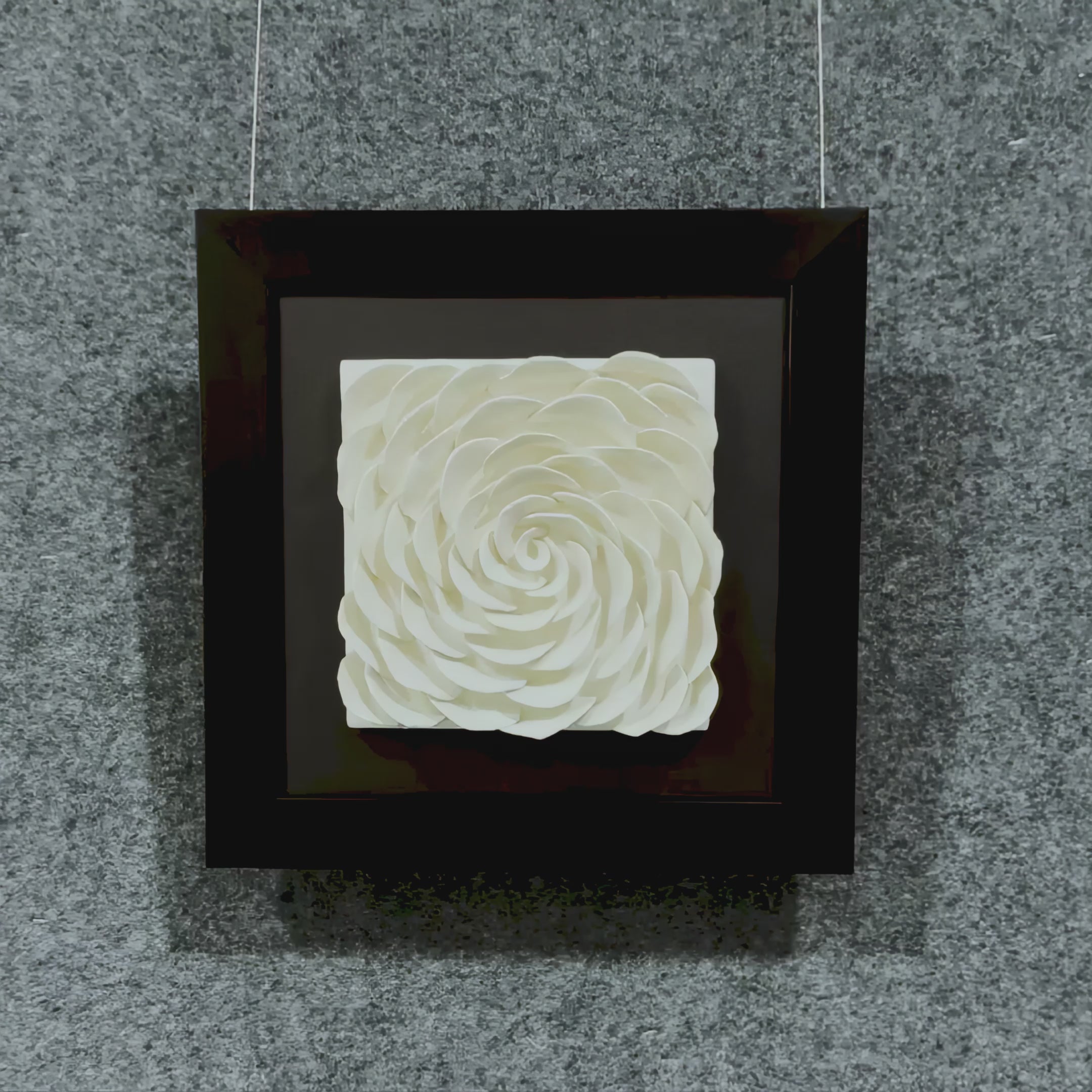 A Video showcasing the Harmonia 3D Rose Wall Installation, highlighting layered ceramic petals in soft ivory tones, framed in black with textured backdrop for dramatic depth