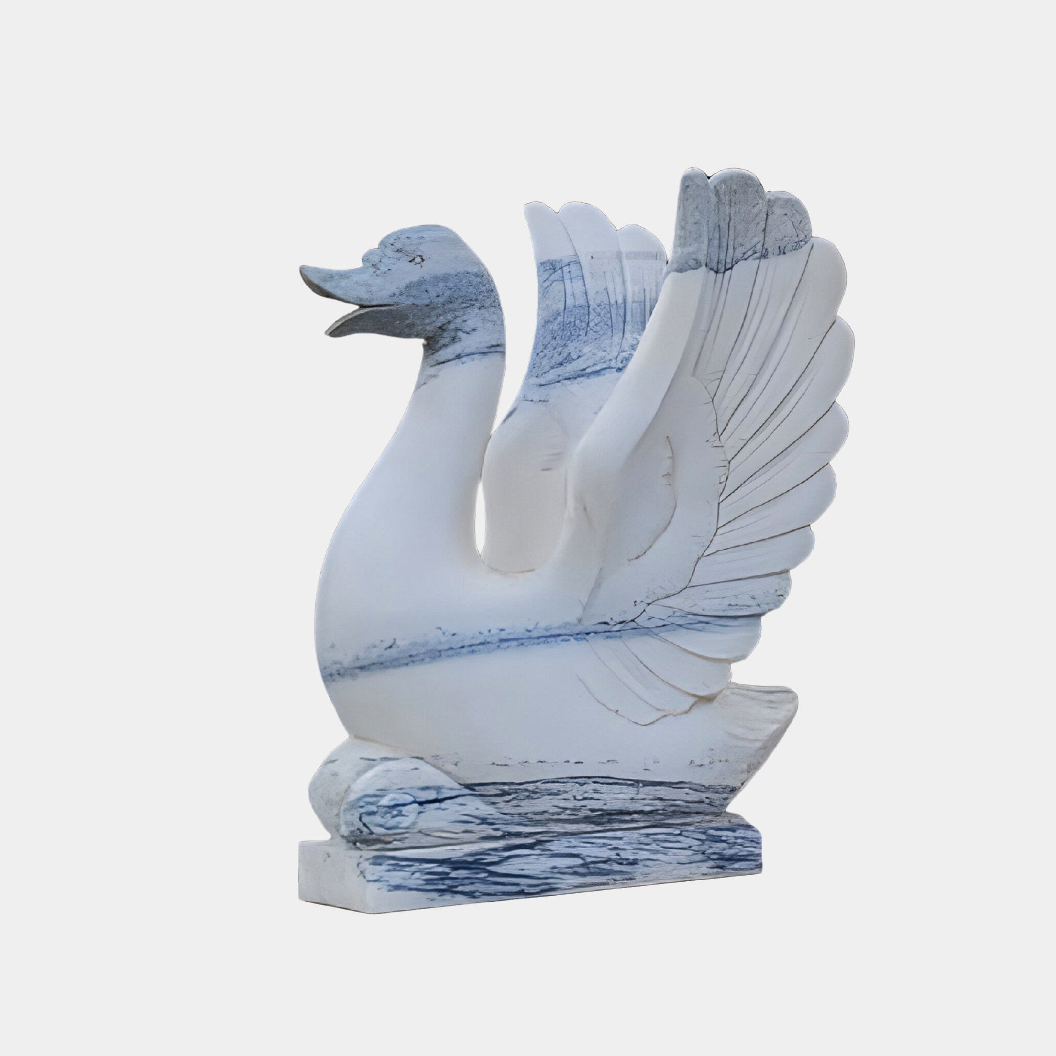 The Wings-Lifted Swan II Marble Outdoor Sculpture by Giant Sculptures features hand-carved blue accents, wings raised and beak open, standing elegantly on a rectangular base. Height: 120cm.