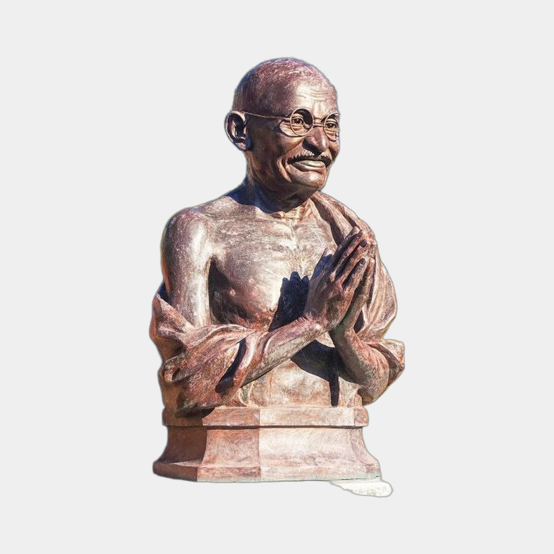 Giant Sculptures Traditional Bespectacled Elder Bust in reddish-brown cast bronze, hands in namaste, on a two-tiered stone plinth against a light grey background.