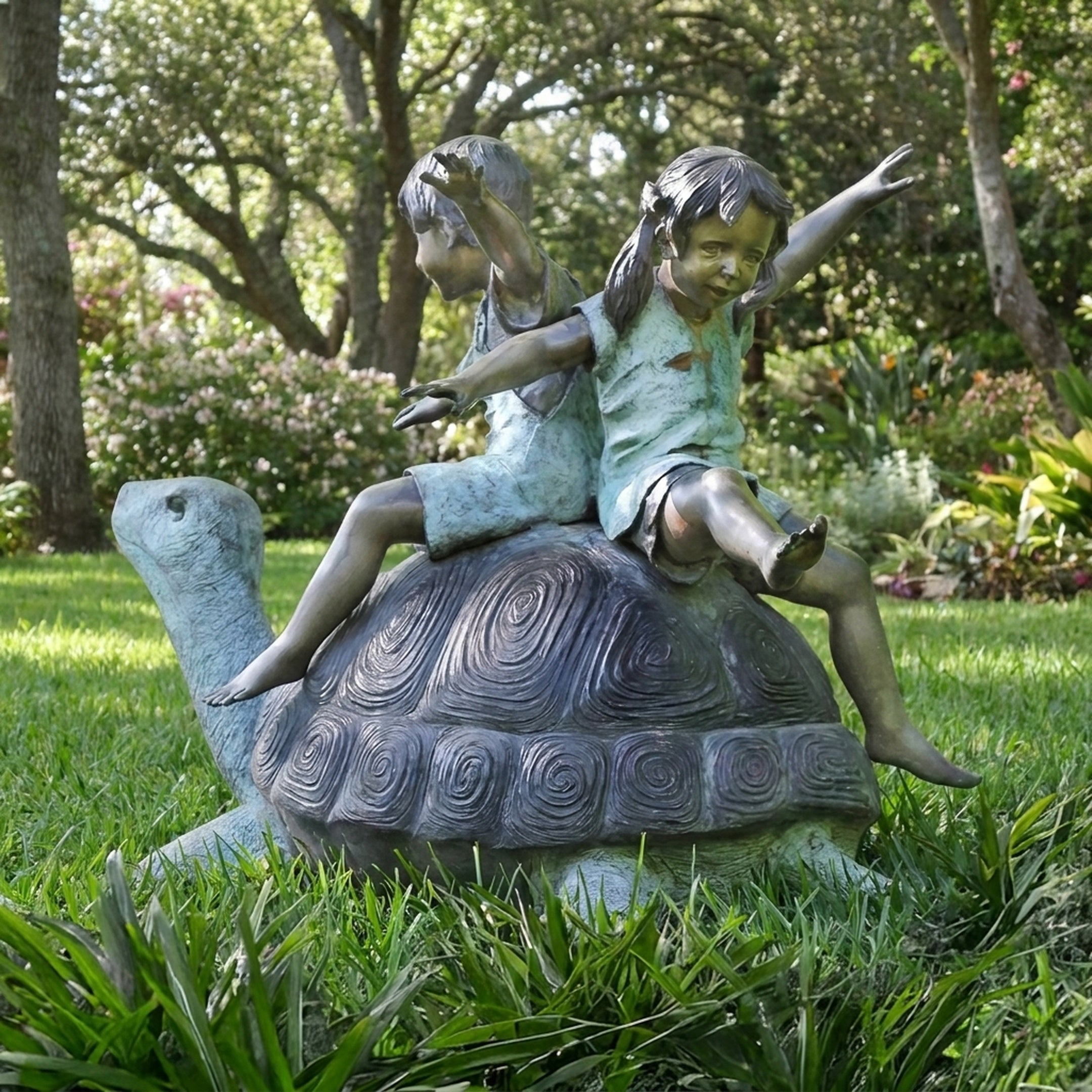 Giant Sculptures Traditional Children on Tortoise Bronze Sculpture 140cm, two girls seated back-to-back with arms raised on a spiral-shelled tortoise in a garden.