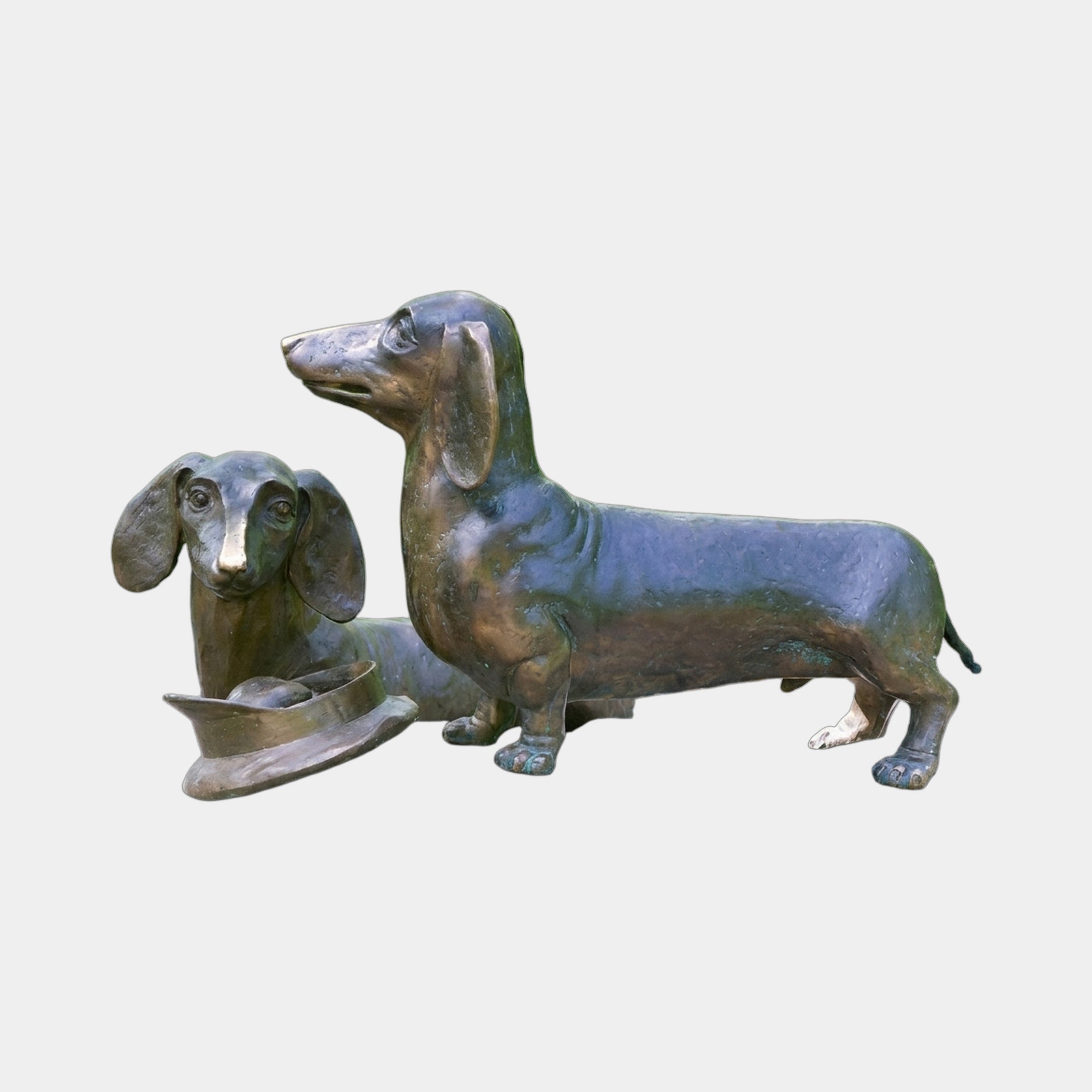Traditional Dachshund Pair Bronze Sculpture by Giant Sculptures, showing one standing alert and the other resting beside a bronze bowl, antique brown patina, plain background.