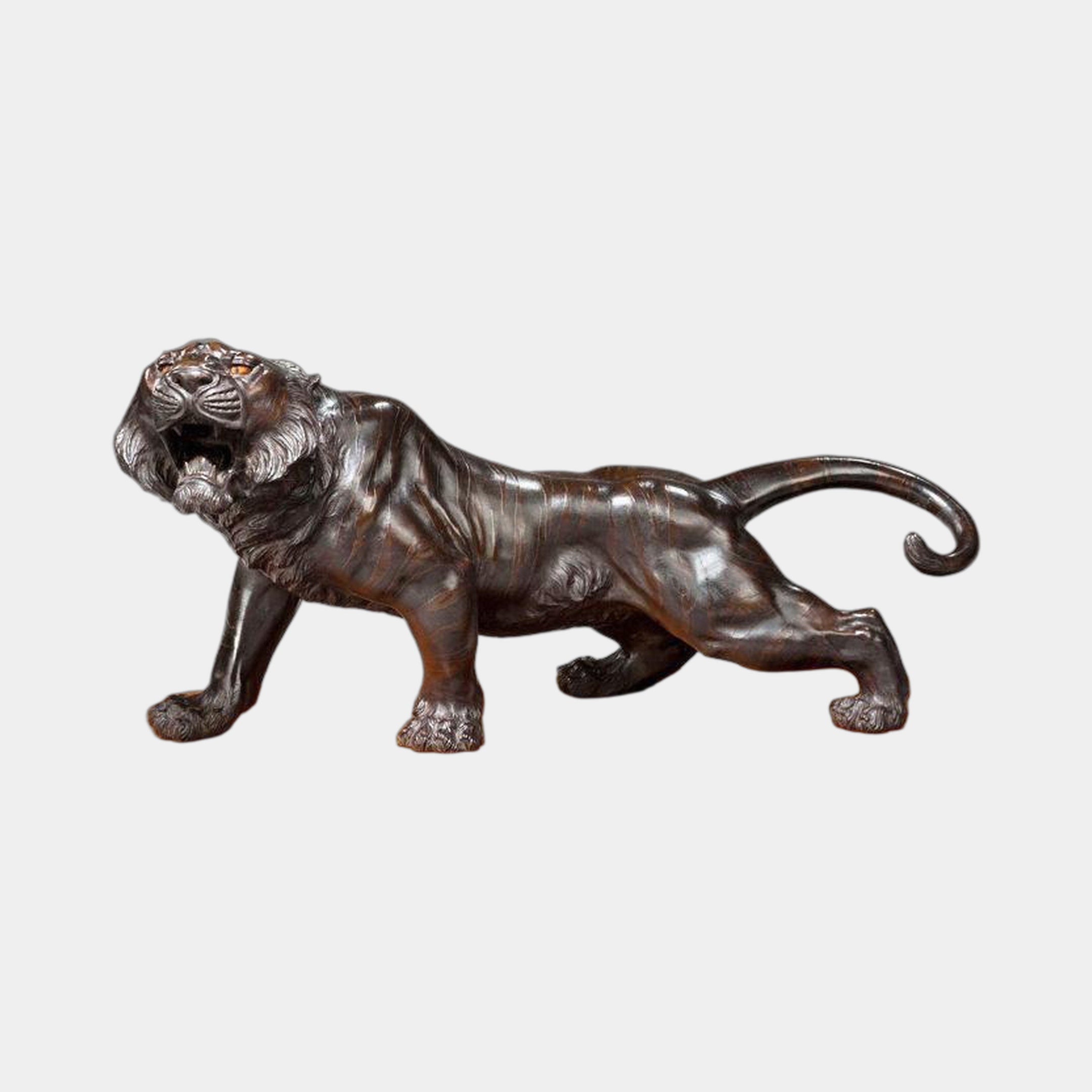 Traditional Prowling Tiger Bronze Sculpture by Giant Sculptures shown in side profile, mid-stalk with open snarling mouth and curled tail, dark brown patina on a plain background.