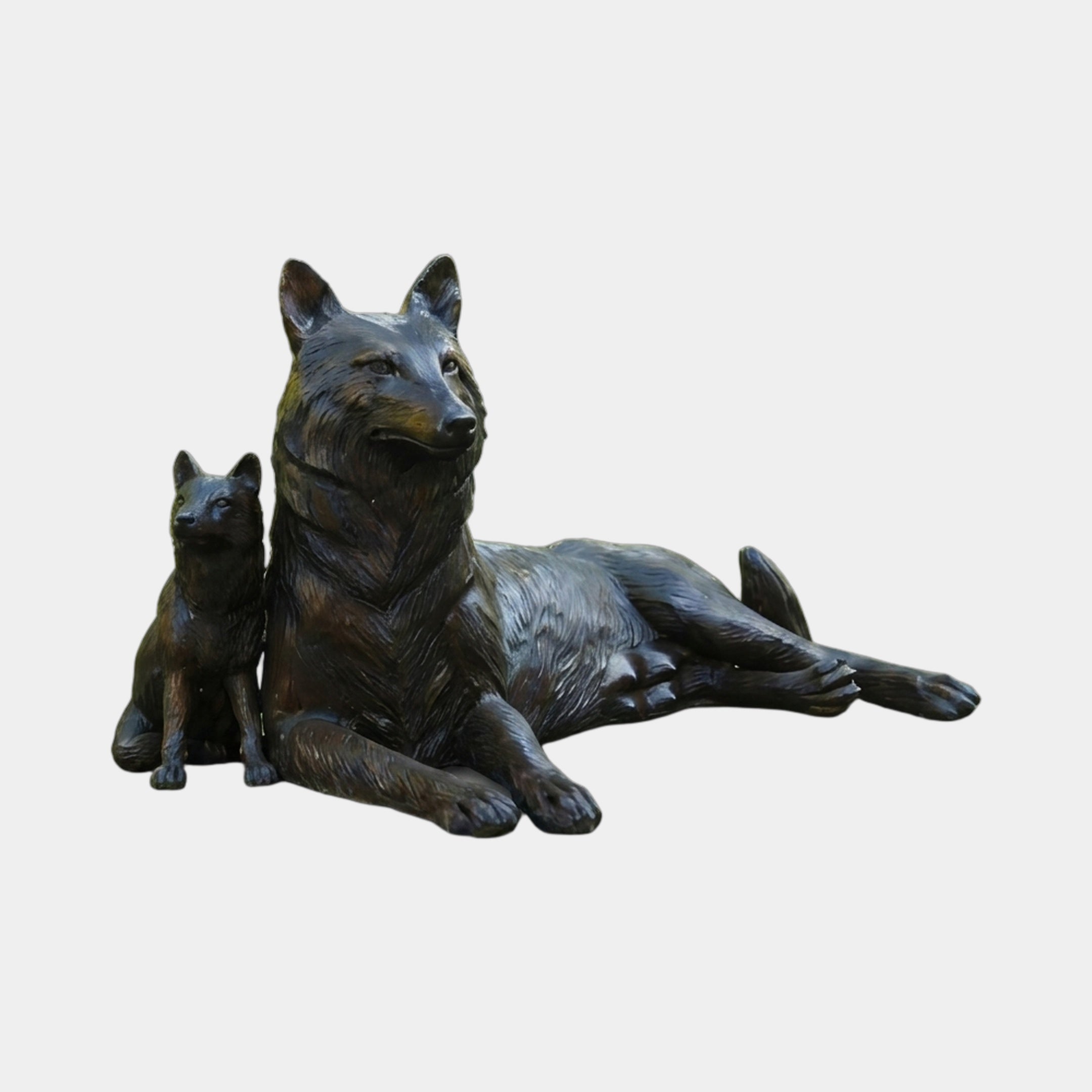 Traditional Reclining German Shepherd and Puppy Bronze Sculpture by Giant Sculptures, dark patina finish with adult lying beside seated puppy on a plain background.