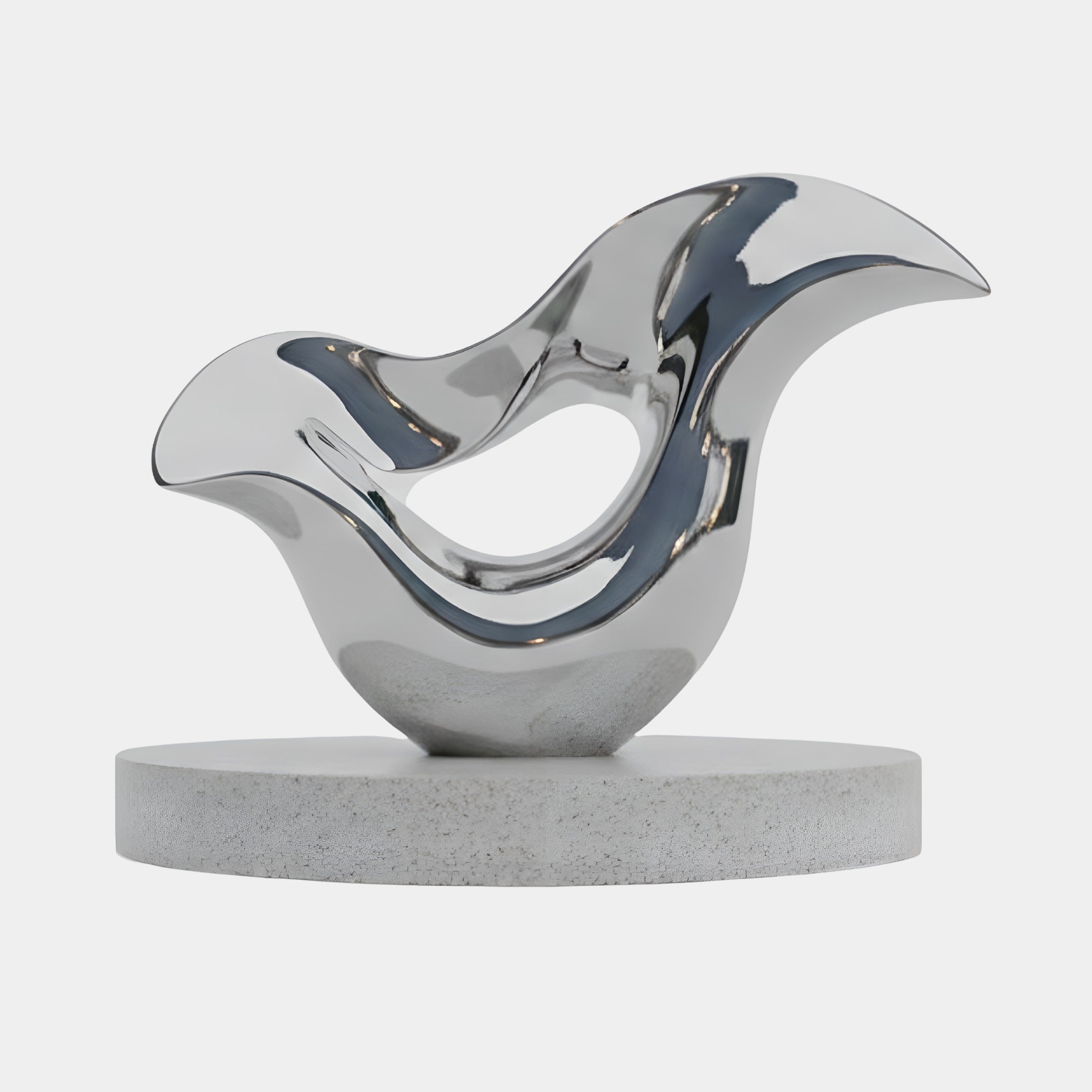The Wisp Silver Abstract Steel Sculpture (200cm) by Giant Sculptures features flowing curves, a bird-like form, and sits atop a round light gray stone base, showcased against a plain white background.