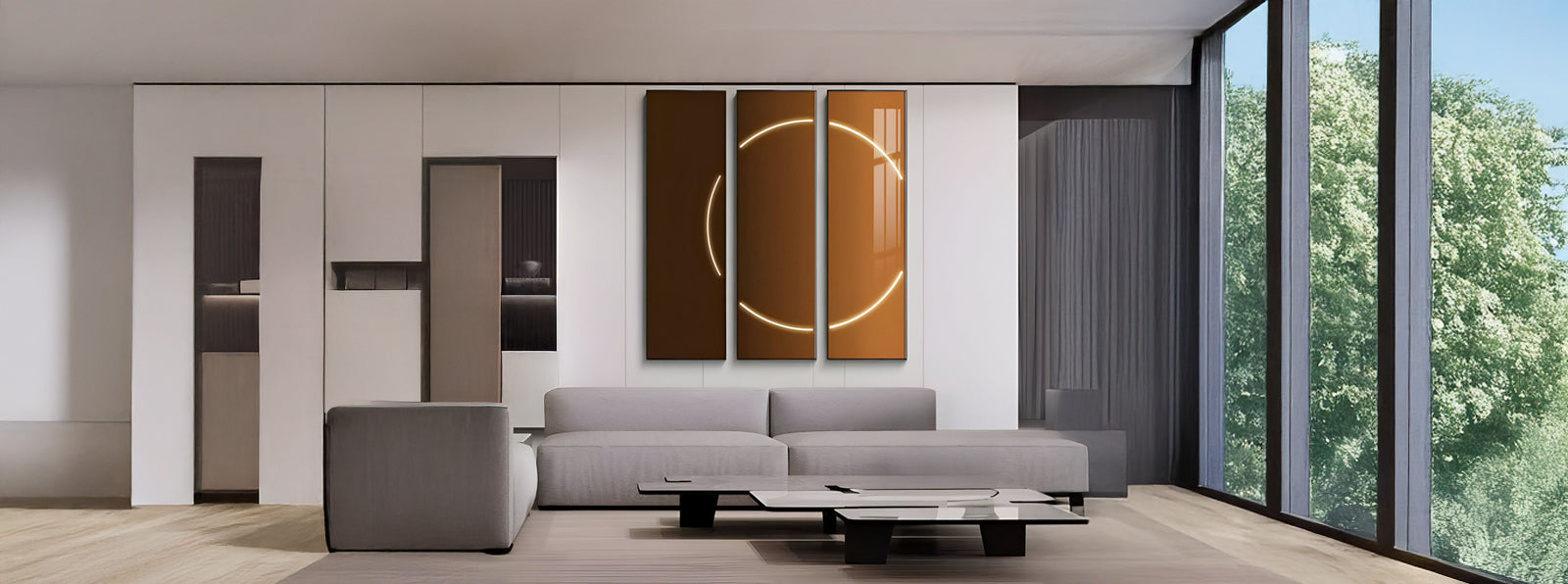 Modern living room with a gray sofa, low coffee table, abstract circular wall art, floor-to-ceiling windows, and a view of green trees outside. Minimalist decor and neutral color palette.