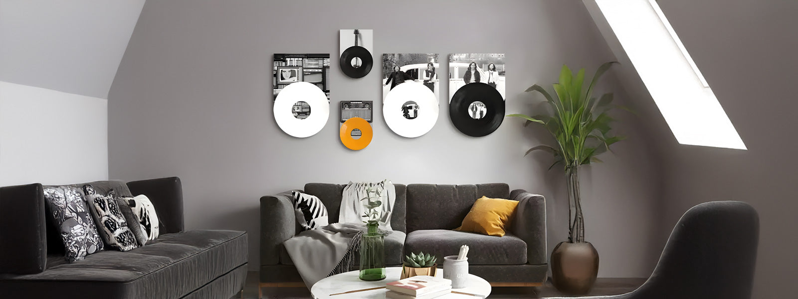 A modern living room with a dark gray sectional sofa, patterned pillows, and a round coffee table. Unique circular art pieces decorate the wall. A skylight and a potted plant add natural elements to the space.