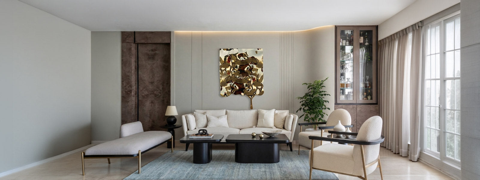 Gold-toned abstract metal wall art above a cream sofa in a modern living room with dark coffee tables, chaise lounge, potted plant, and glass bar cabinet.