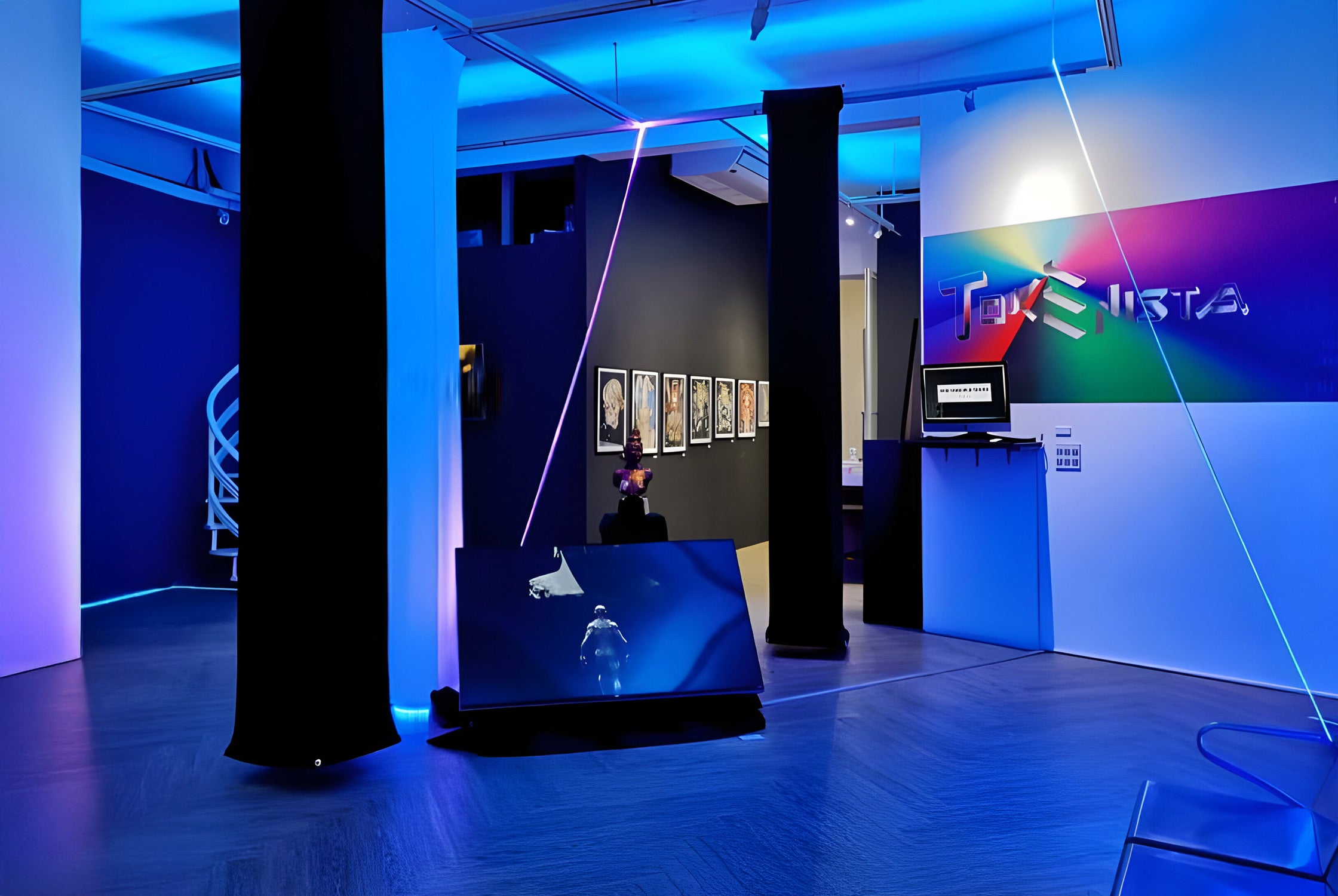 A modern art gallery with neon blue and purple lighting. The room includes abstract installations, digital screens, framed artwork on the walls, and a sign reading TOP LISTA with colorful letters.