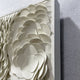 A close-up of the Riverine Flow Pearl White Textured Triptych Wall Art by Giant Sculptures, featuring layered, overlapping circular shapes that create a sculptural textured effect within a rectangular frame.
