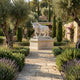 The Charging Bull White Marble Outdoor Sculpture - 150cm by Giant Sculptures stands on a stone pedestal in a lush Mediterranean garden with olive trees, lavender, cypress, stone walls, and flowering plants.