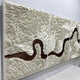 The Riverine Flow Pearl White Textured Triptych Wall Art by Giant Sculptures showcases layered cream and pearl white shapes like feathers or waves, accented by a winding dark brown path through each modern panel.