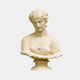 The Classical Female Marble Bust Sculpture - 70cm by Giant Sculptures features a woman with wavy hair, downcast eyes, and refined features, draped in fabric atop a decorative base against a light background.