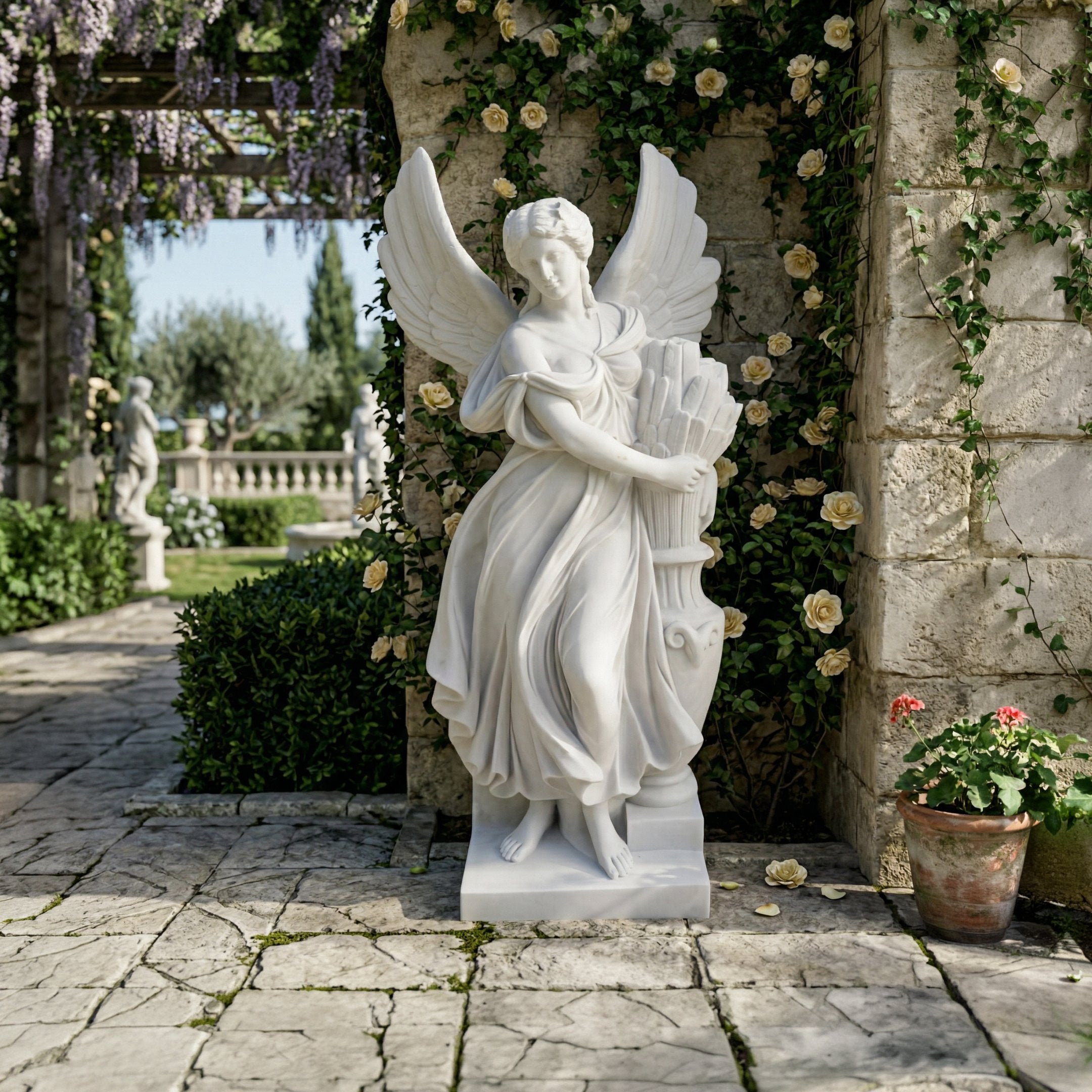 The 200cm Harvest Grace Angel Marble Outdoor Sculpture by Giant Sculptures stands on a stone patio among flowering vines, a potted plant, and lush greenery, with another angel marble outdoor sculpture in the background.