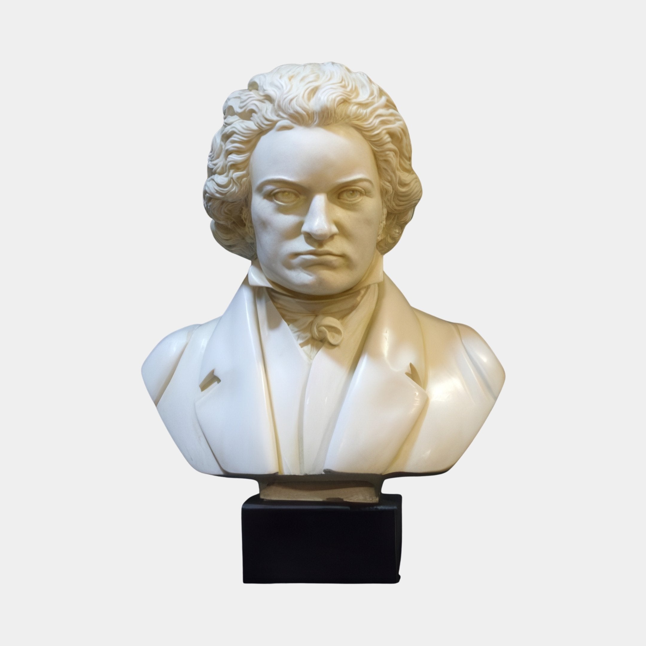The Beethoven Marble Bust Sculpture - 60cm by Giant Sculptures features a white marble bust of Beethoven with curly hair, dressed in a formal coat and cravat, set on a black rectangular base against a plain background.