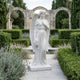 The Heartfelt Bouquet Angel Marble Outdoor Sculpture by Giant Sculptures stands 200cm tall, featuring a hand-carved angel with a bouquet—an elegant centerpiece for gardens and outdoor spaces.