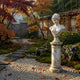 The Classical Youth Marble Bust Sculpture - 65cm by Giant Sculptures sits on a pedestal in a serene garden with autumn trees, moss, gravel, colorful leaves, and a wooden fence in the background.