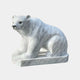 The Seated Polar Bear White Marble Outdoor Sculpture by Giant Sculptures features a sitting polar bear crafted from white marble with subtle gray veining on a rectangular base, appearing to gaze forward.