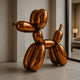 A 100cm Sunset Orange Balloon Dog Sculpture by Giant Sculptures, with a shiny copper finish, is showcased indoors on a tiled floor near a large window, enhancing the artistic vibe of the modern living room in the background.