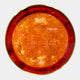 Galaxia Sun Crystal Porcelain LED Wall Art by Giant Sculptures shown head-on, with a textured amber-orange core radiating into a deep red ring and brass-toned edge.