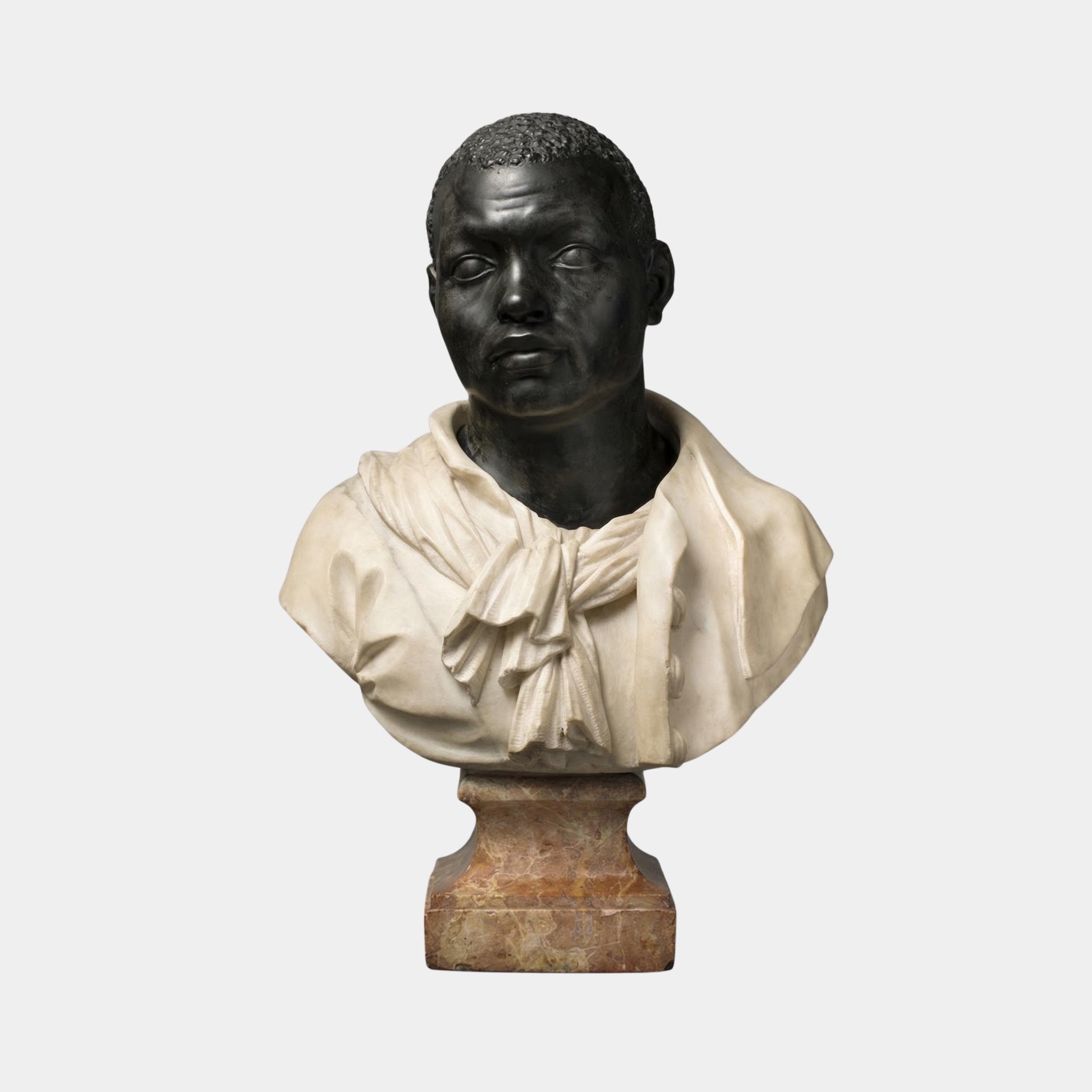 Moor Marble Bust Sculpture by Giant Sculptures featuring a dark polished stone male portrait with white marble draped shirt and open collar, mounted on a warm-toned marble pedestal against a plain light background.