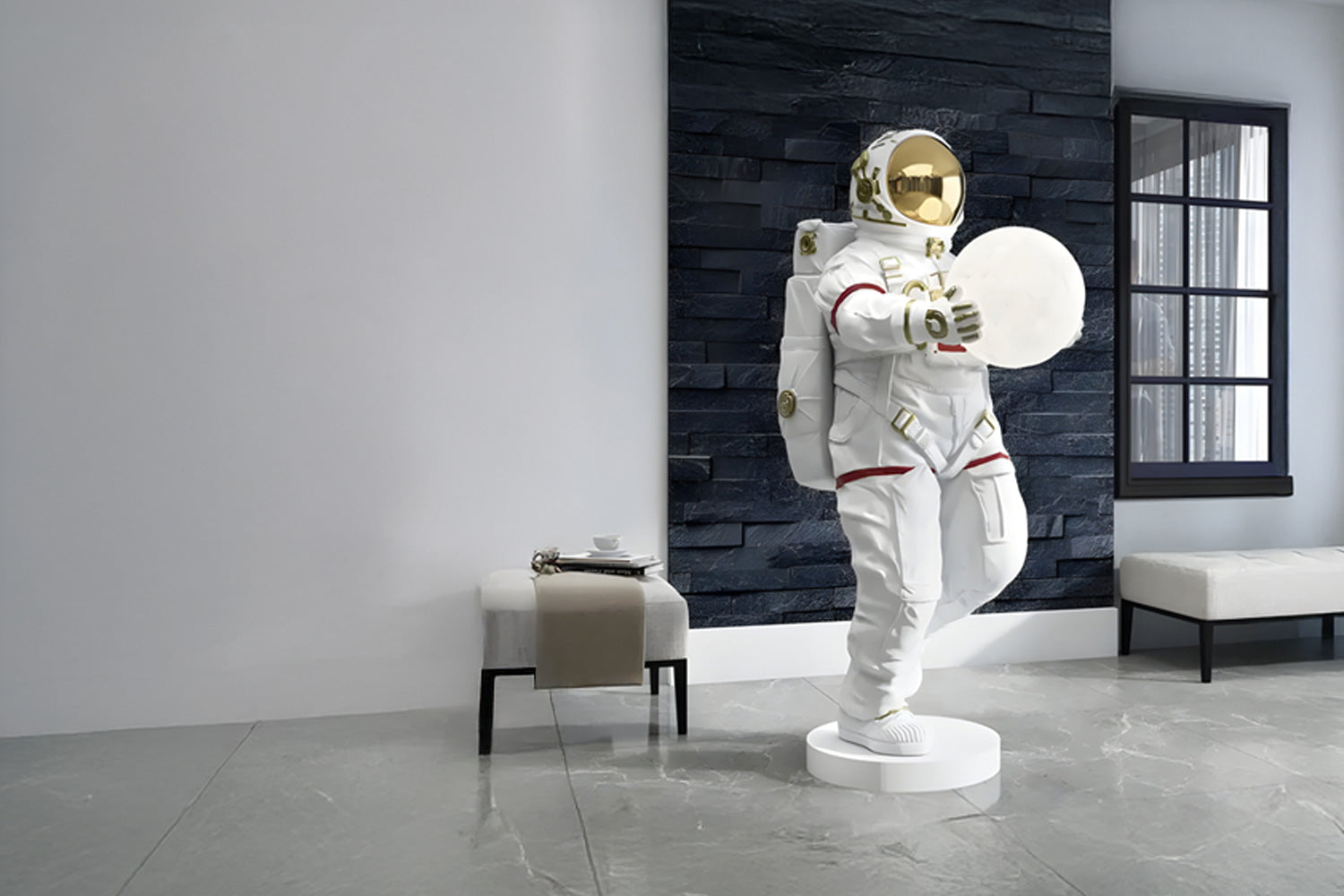 A modern interior features a large astronaut statue holding a glowing sphere. The astronaut, in a white suit with gold accents, stands against a dark stone wall. Nearby are a beige bench and a small table with a teacup.