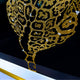 Close-up of the Glacia Dual Jaguar Crystal Hanging Framed Wall Art showing gold and clear crystal inlays tracing the jaguar's form against a dark panel.