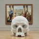 The Marble Skull Marble Sculpture - 25cm by Giant Sculptures stands on a wooden gallery floor before a framed classical painting of figures in an architectural setting, evoking the essence of a memento mori.