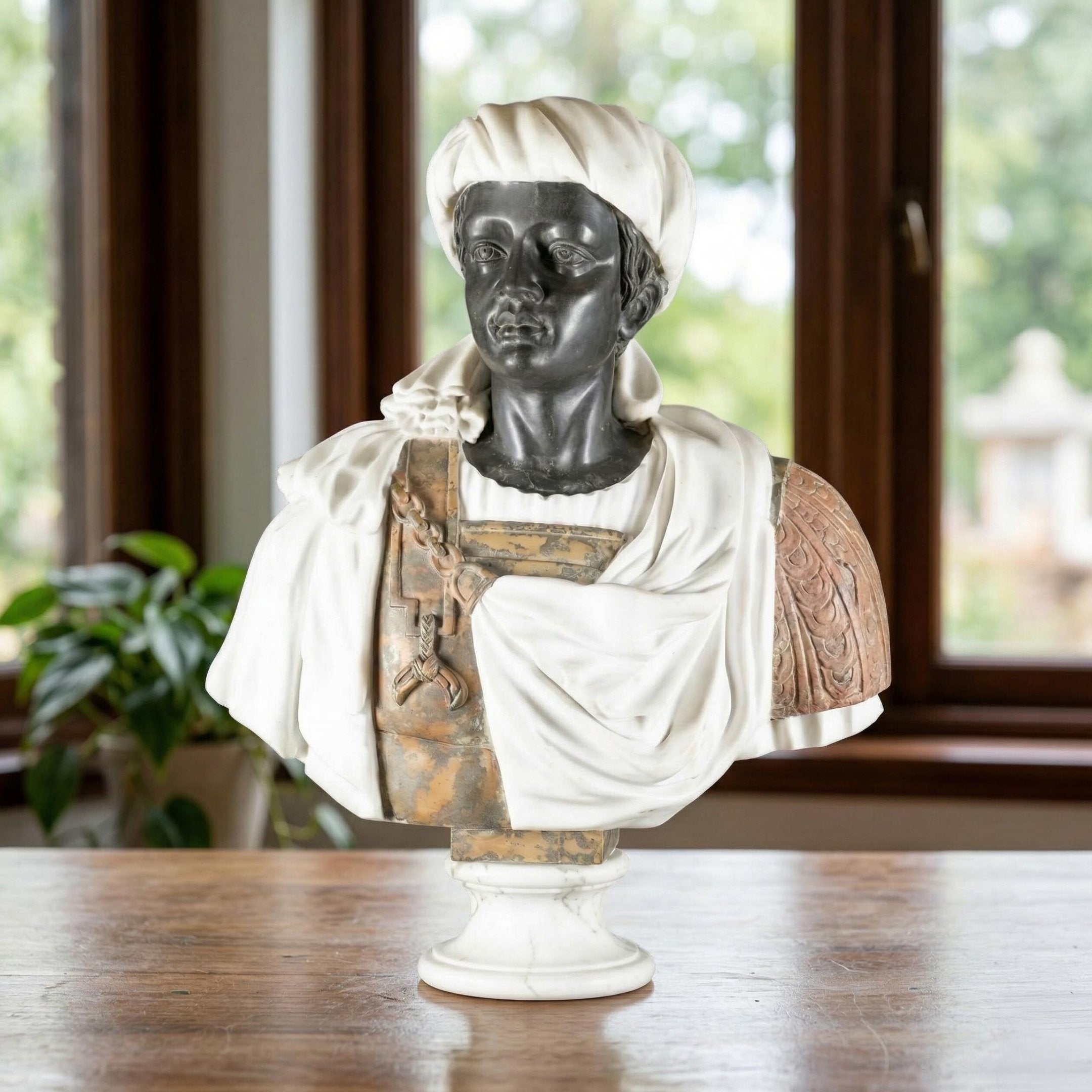 The Giant Sculptures Moorish Turban Marble Bust Sculpture (75cm) features a detailed figure in a headscarf and draped attire, set on a table by large windows with lush greenery—a striking example of Baroque decorative art.