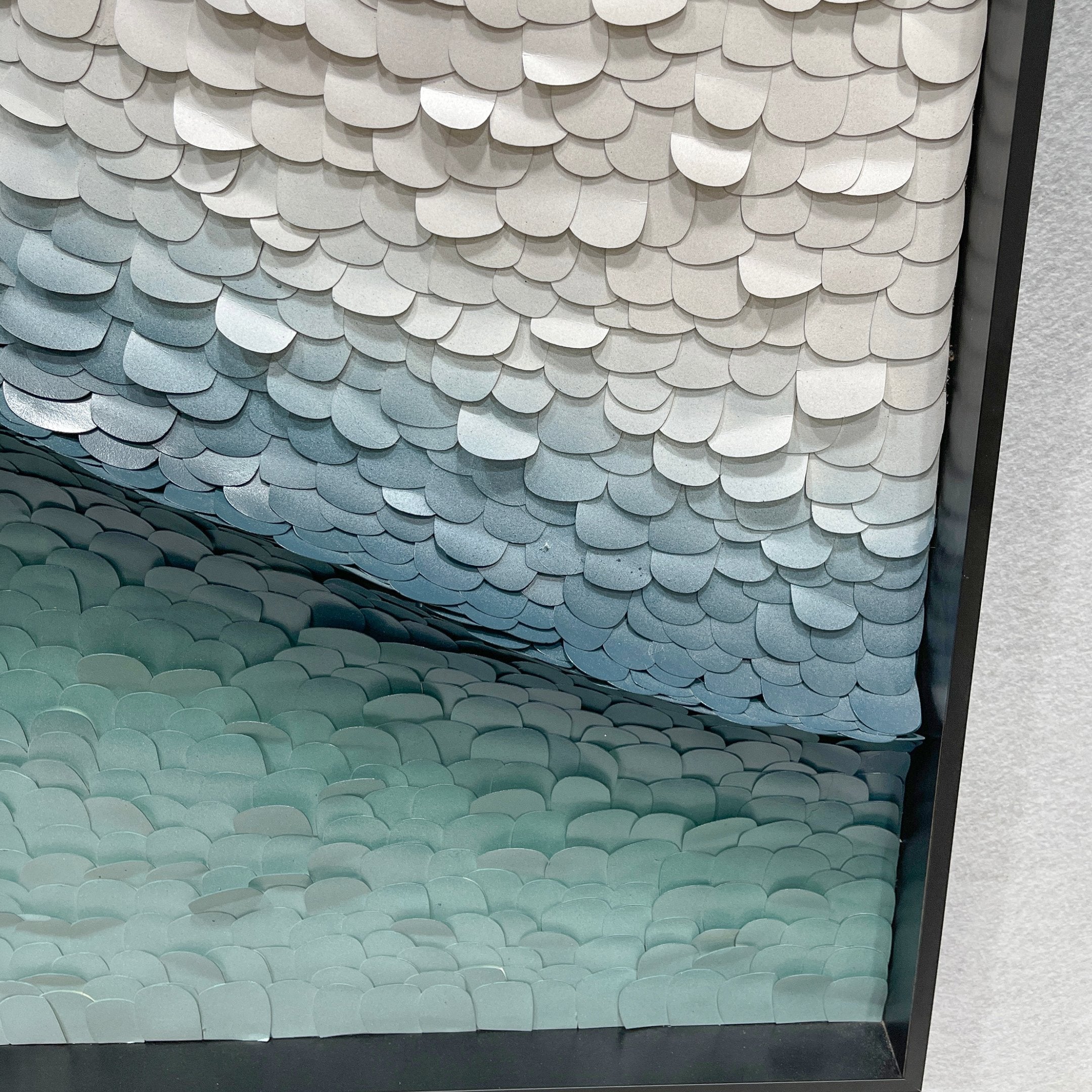 Close-up corner detail of the Seravelle Mist Blue Gradient Layered 3D Paper Wall Art showing overlapping scale-like paper forms shifting from white to teal.