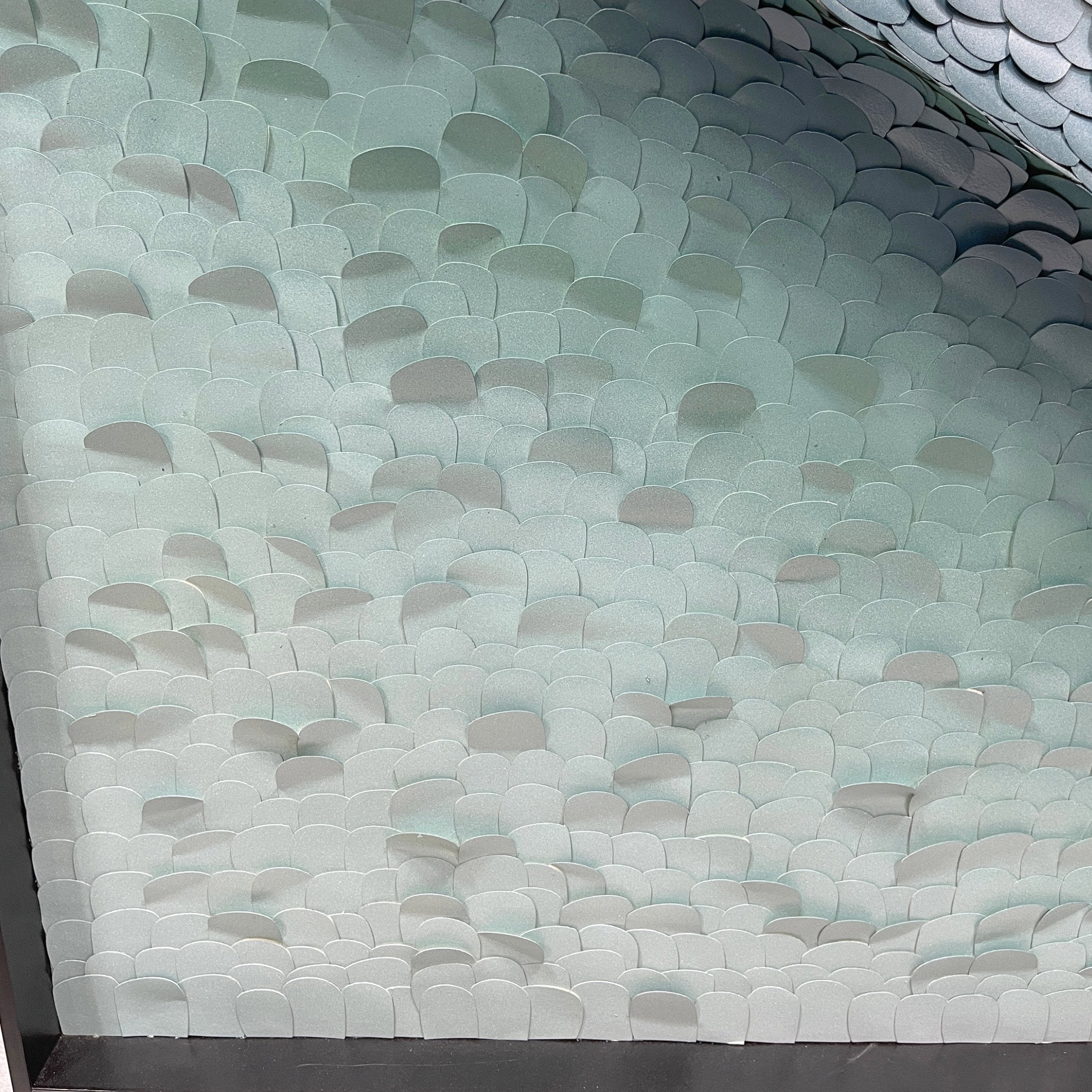 Close-up angled view of the Seravelle Mist Blue Gradient Layered 3D Paper Wall Art showing overlapping scale-like paper forms in soft white and pale mist-blue tones.