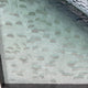 Close-up angled view of the Seravelle Mist Blue Gradient Layered 3D Paper Wall Art showing overlapping scale-like paper forms in soft white and pale mist-blue tones.