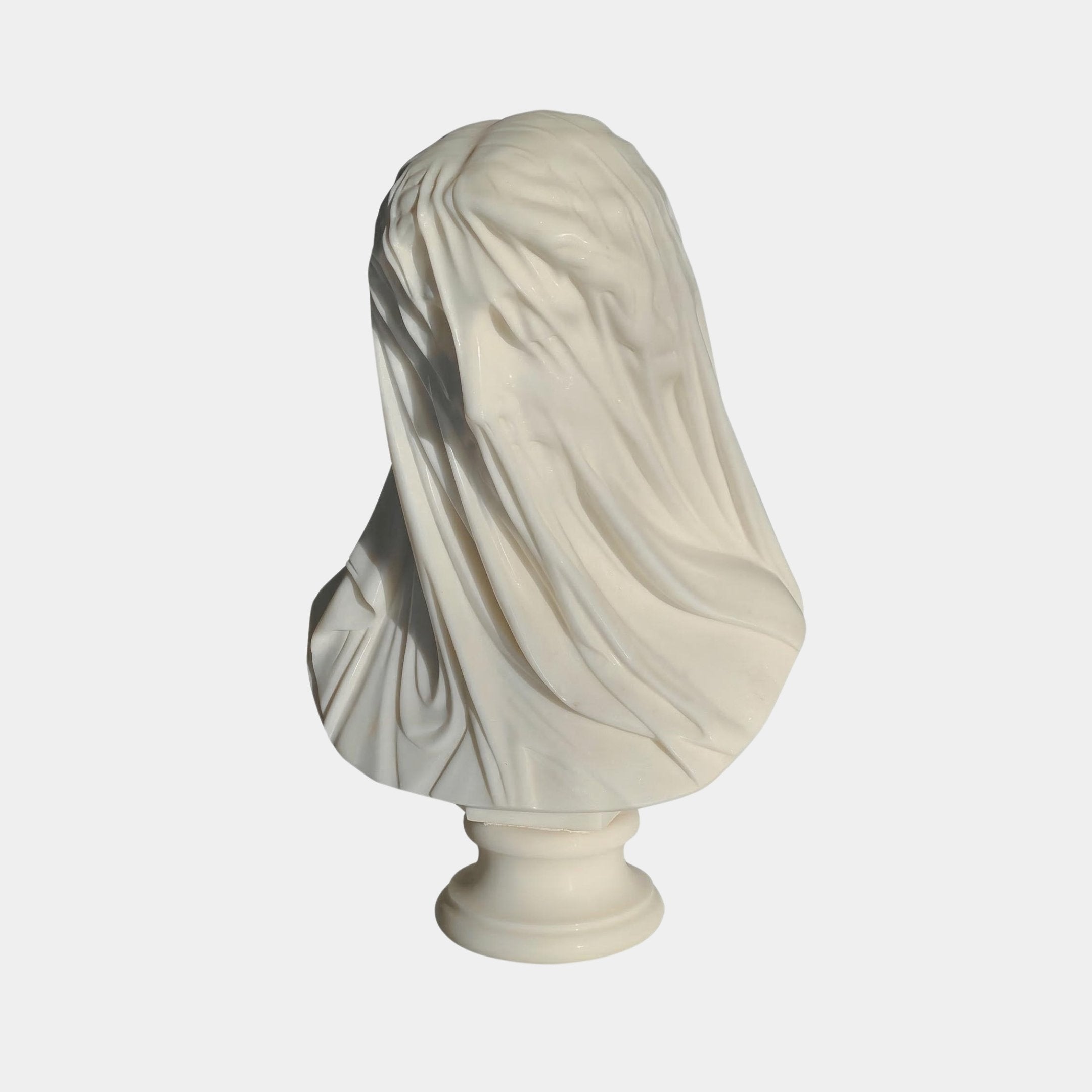 The Veiled Lady Marble Bust Sculpture - 55cm by Giant Sculptures features a hand-carved draped veil revealing delicate facial details, elegantly displayed on a round pedestal.
