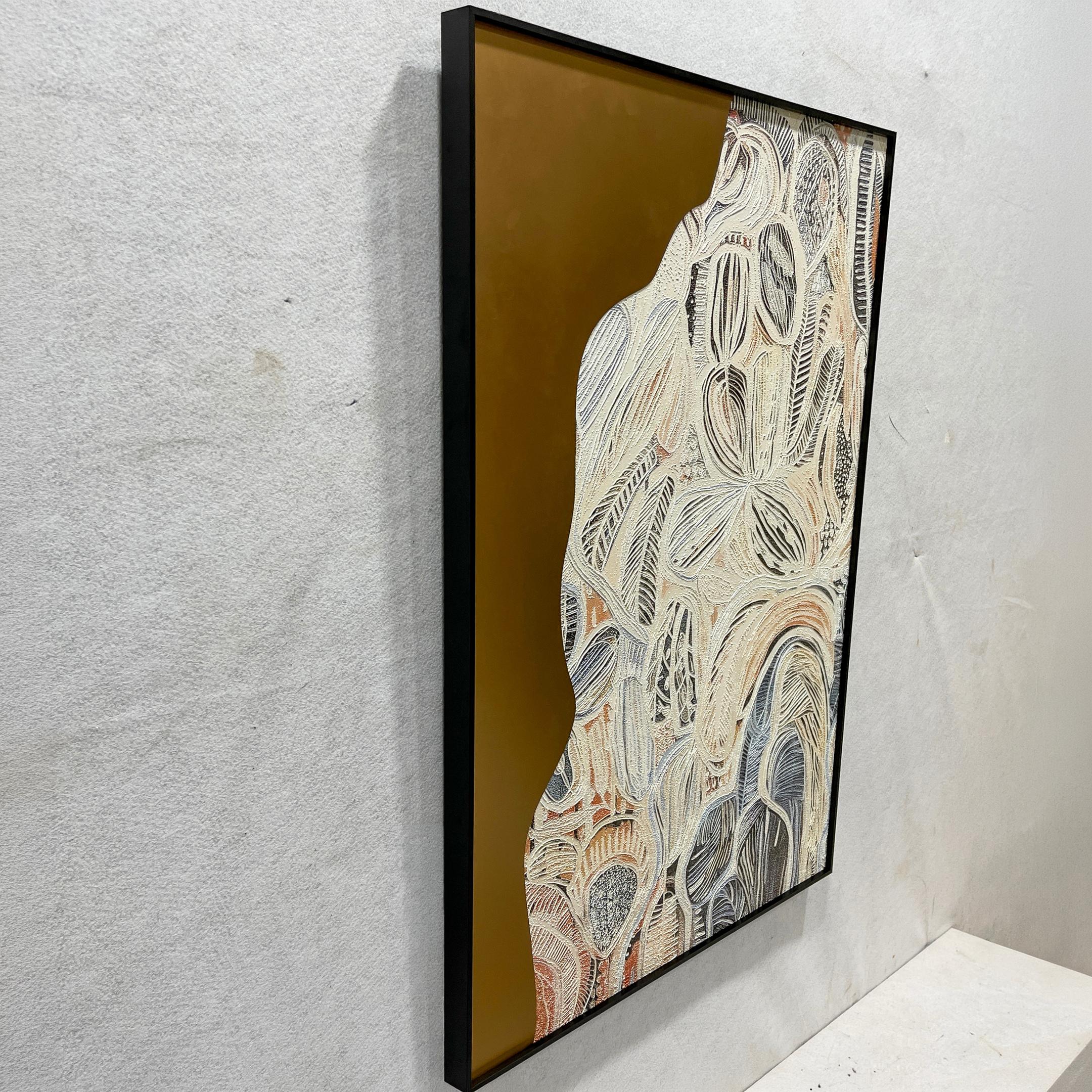 Aurista Botanical Flow Abstract Cotton Spray Wall Art viewed at an angle, showing raised beige and black leaf forms on a metallic gold ground in a black frame.