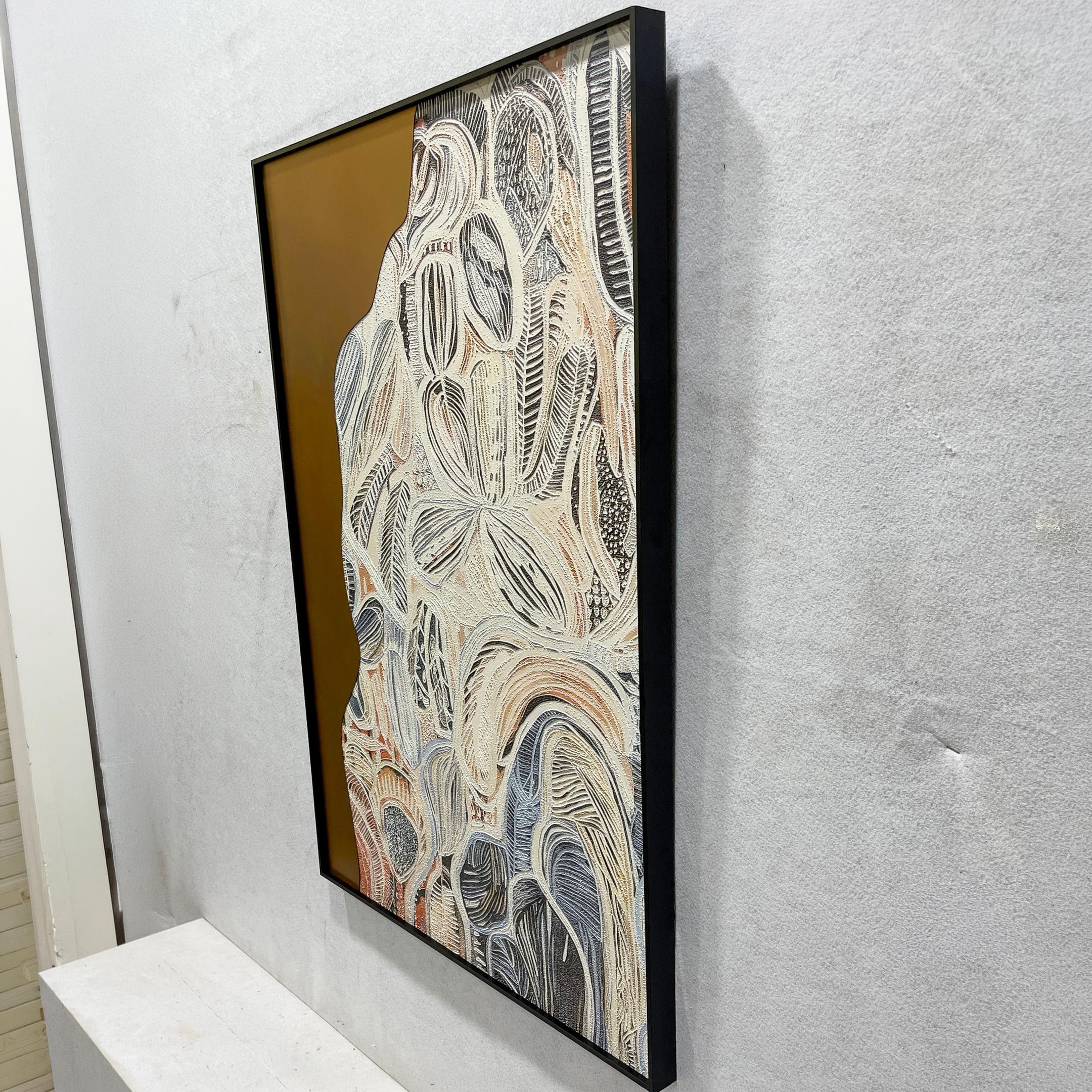 Aurista Botanical Flow Abstract Cotton Spray Wall Art shown at an angle, with raised beige, white, black, and blue leaf forms on a gold ground in a black frame.