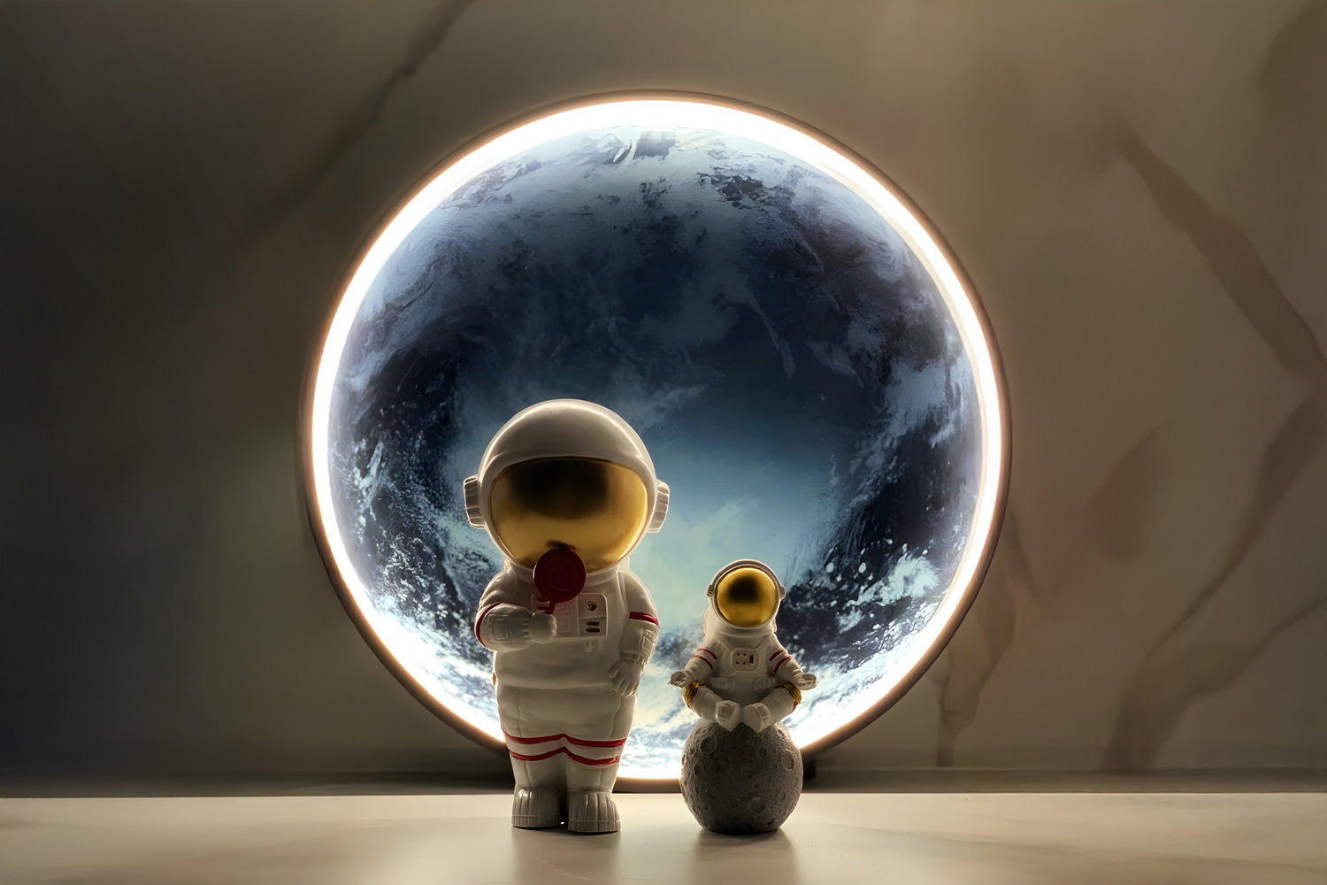 Two astronaut figurines stand on a reflective surface. One holds a red flag, while the smaller one stands on a rocky sphere. A large illuminated circle in the background resembles Earth from space, casting a soft glow around the figures.