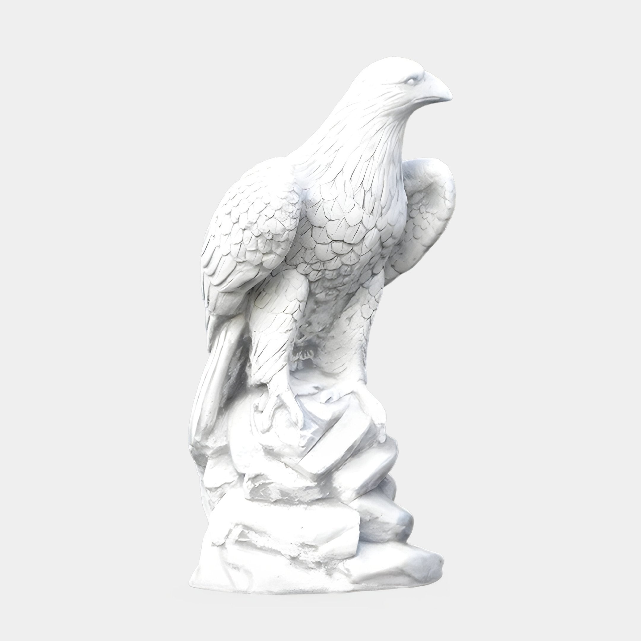 The Giant Sculptures Regal Eagle White Marble Outdoor Sculpture, standing at 120cm, features intricate feather details, a slightly turned head with a curved beak and sharp eyes, perched on a rocky base. The plain background accentuates this stunning masterpiece.